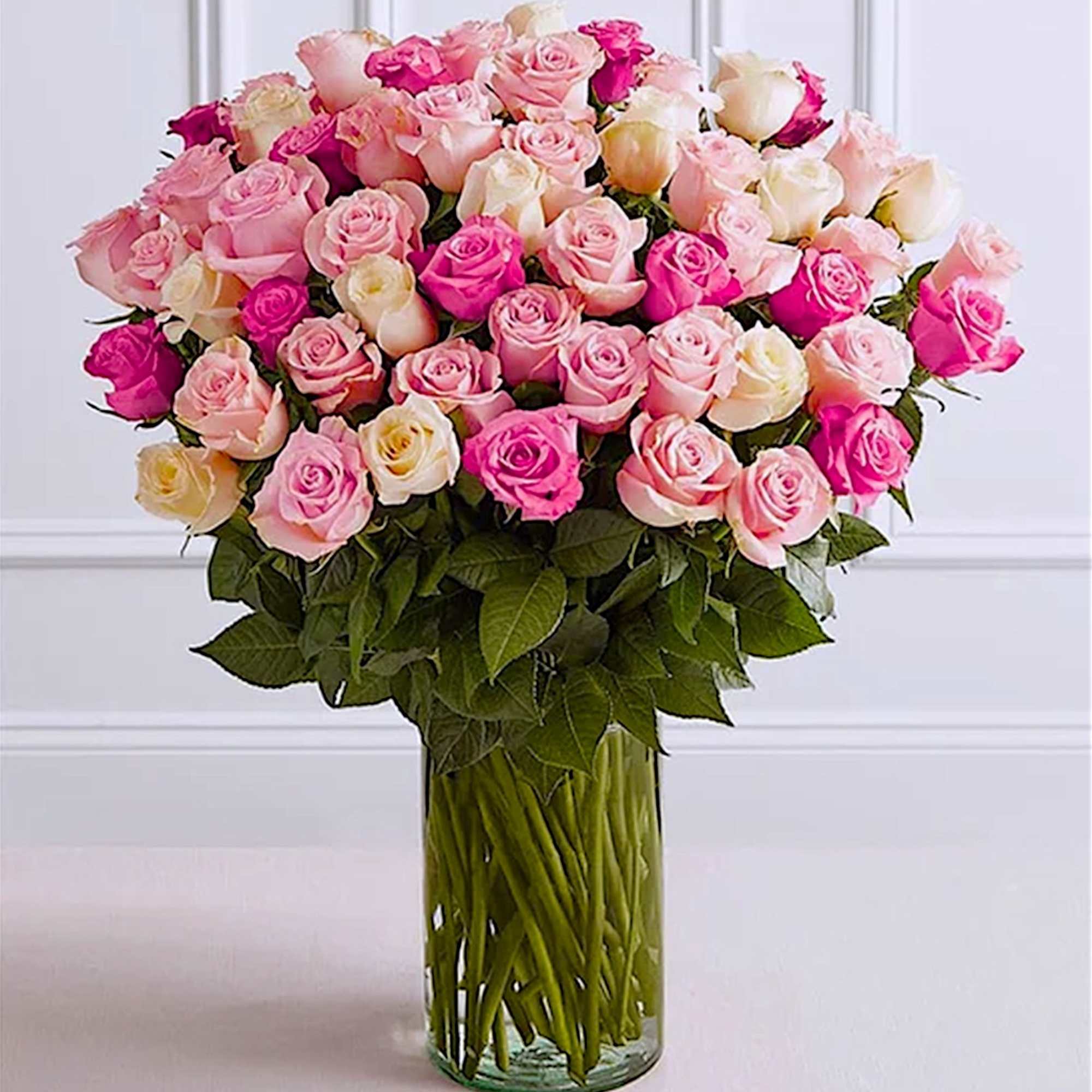 Large bouquet of pink and white roses in a clear glass vase, photo 2 of 6