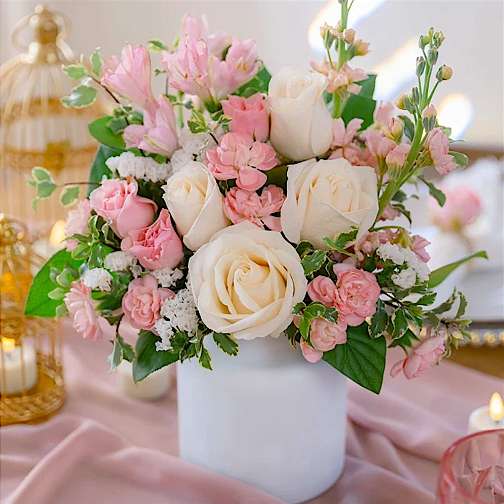 Pink and white rose bouquet in a white vase