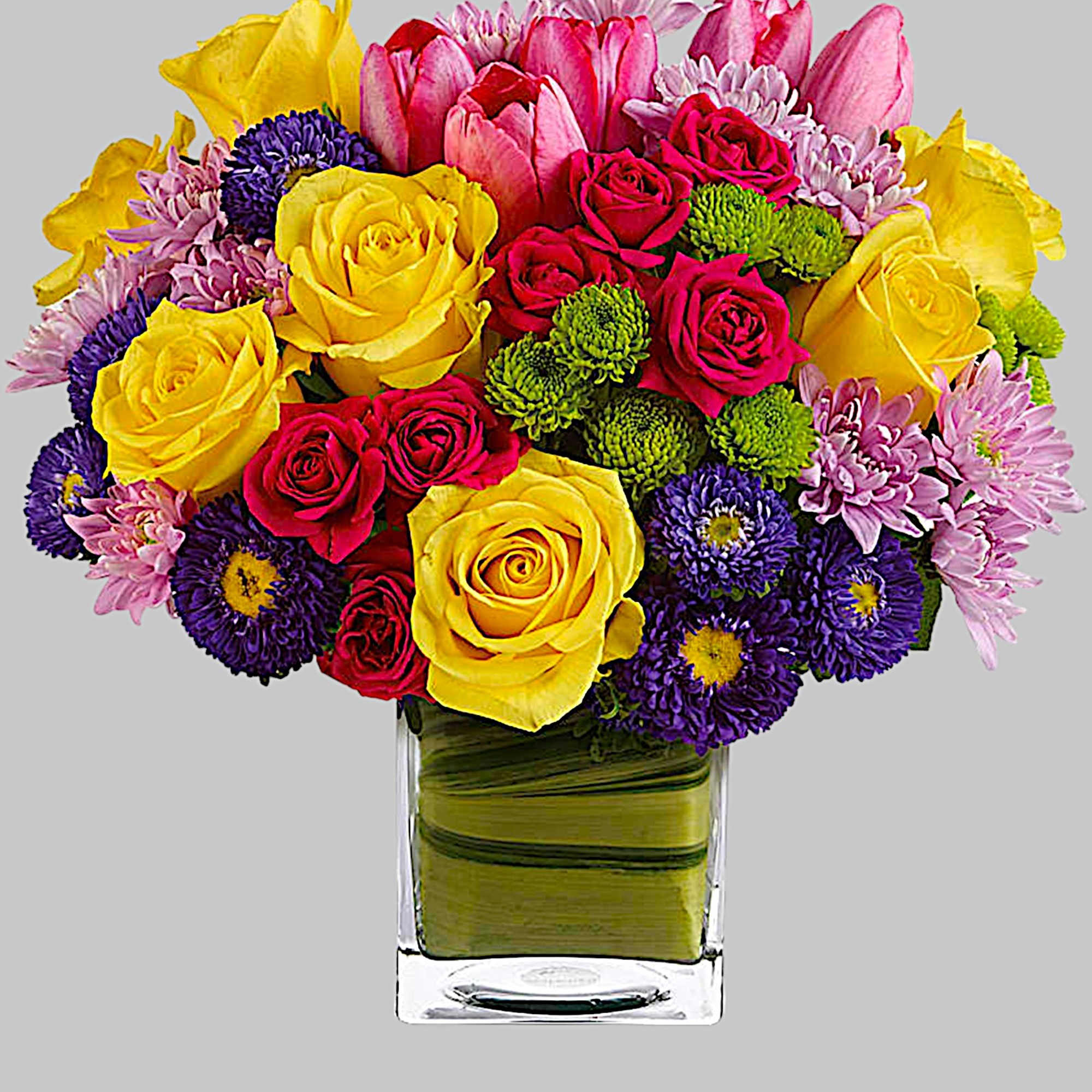 Colorful bouquet of roses, tulips, and daisies in a clear glass vase, photo 4 of 4