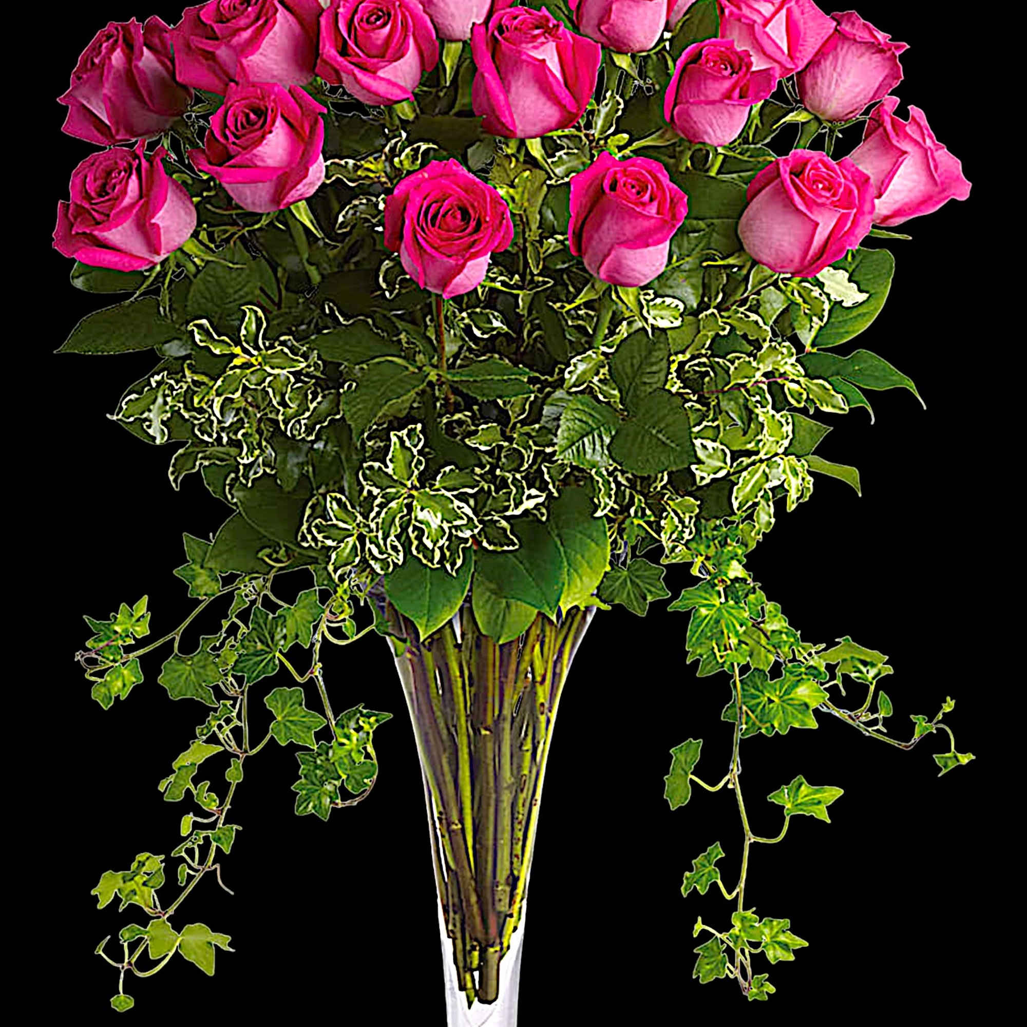 Pink roses arranged in a tall clear glass vase with trailing ivy, photo 3 of 4