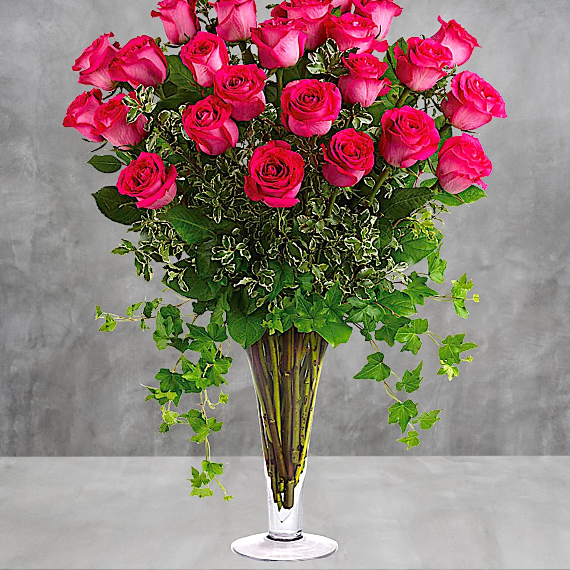Tall bouquet of hot pink roses in a clear glass vase, photo 2 of 4