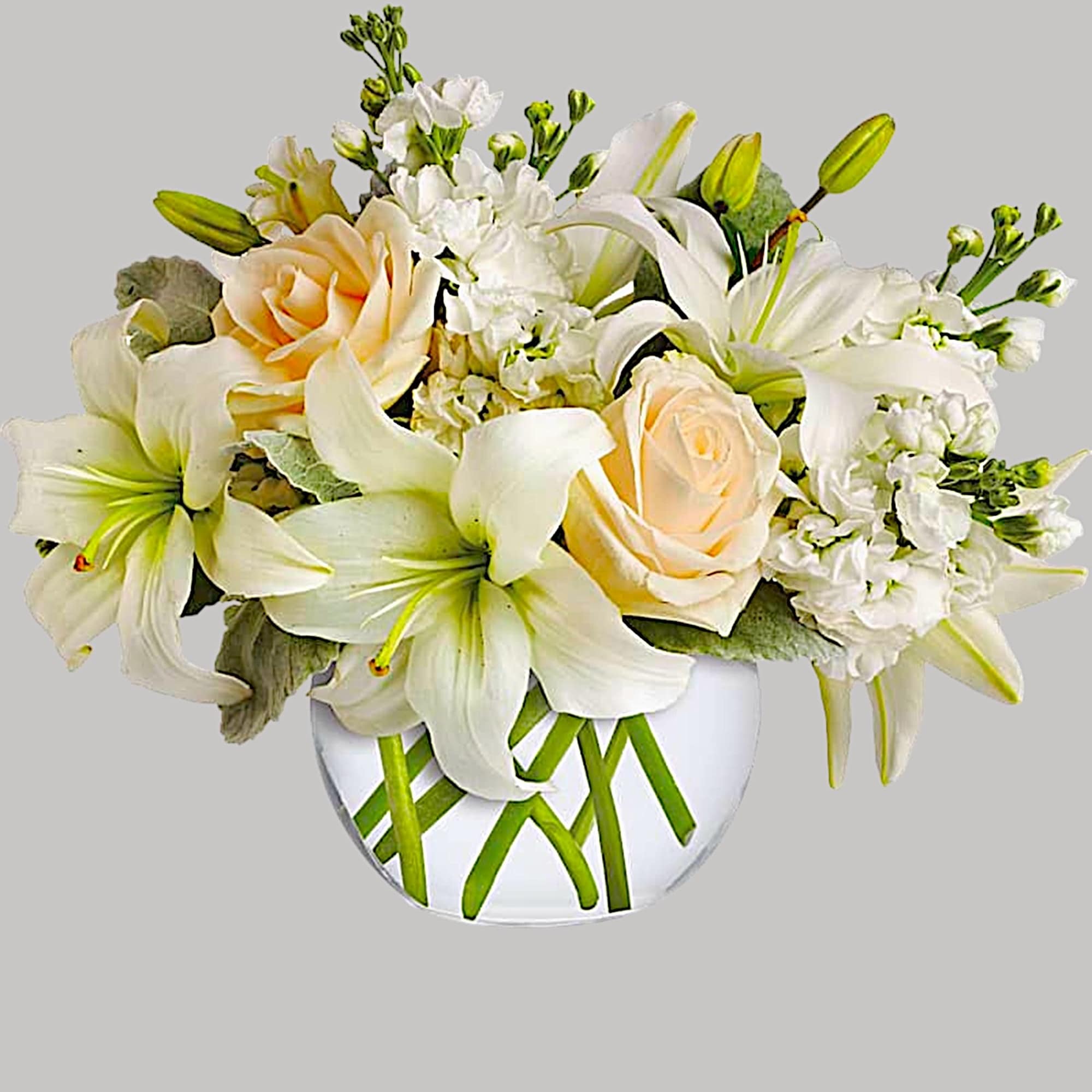 White lilies and pale roses in a glass vase