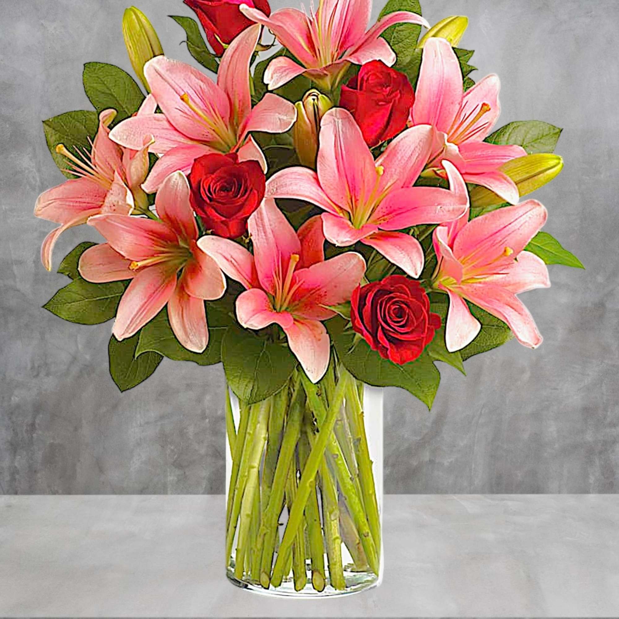 Pink lilies and red roses in a clear glass vase, photo 2 of 4