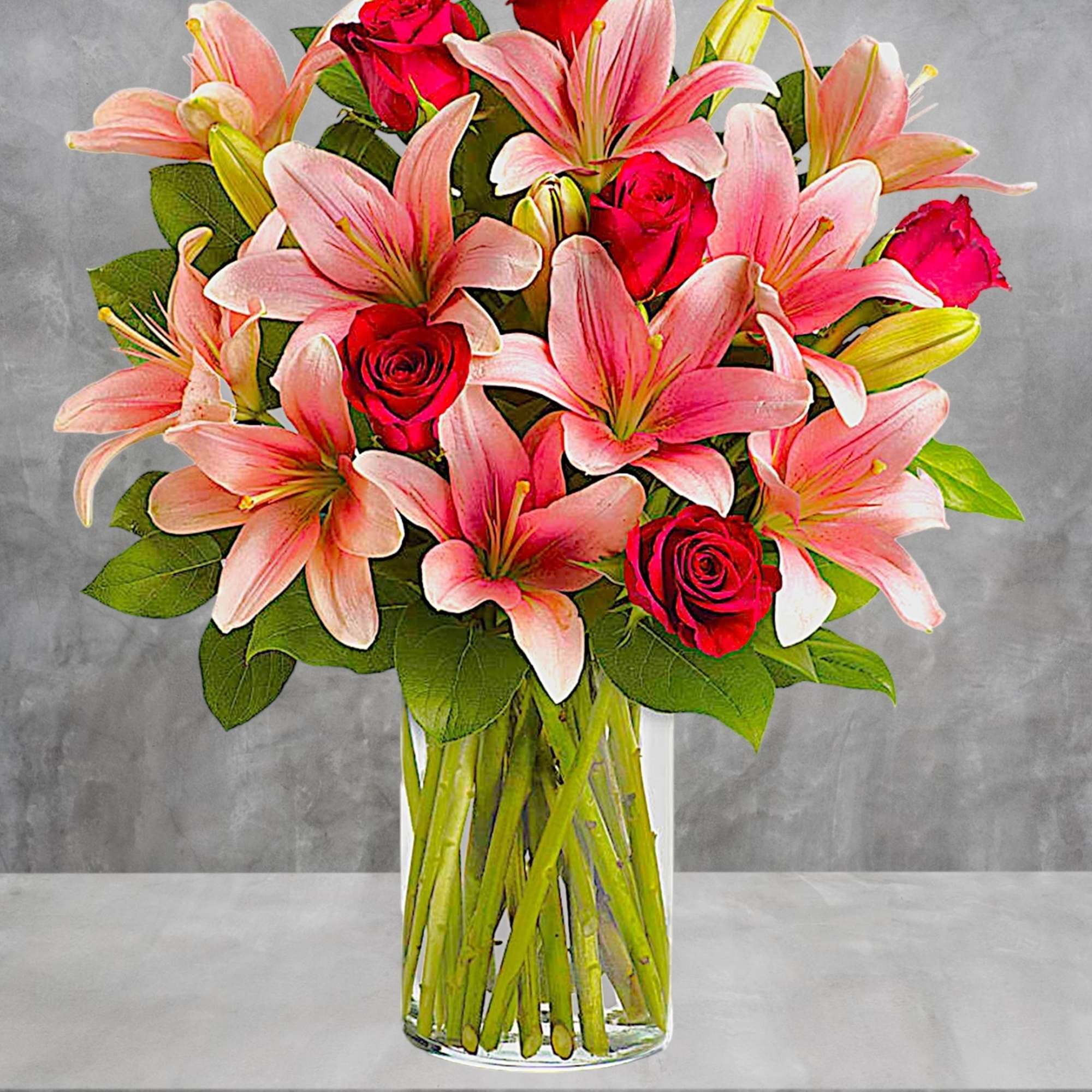 Pink lilies and red roses arranged in a clear glass vase, photo 2 of 4