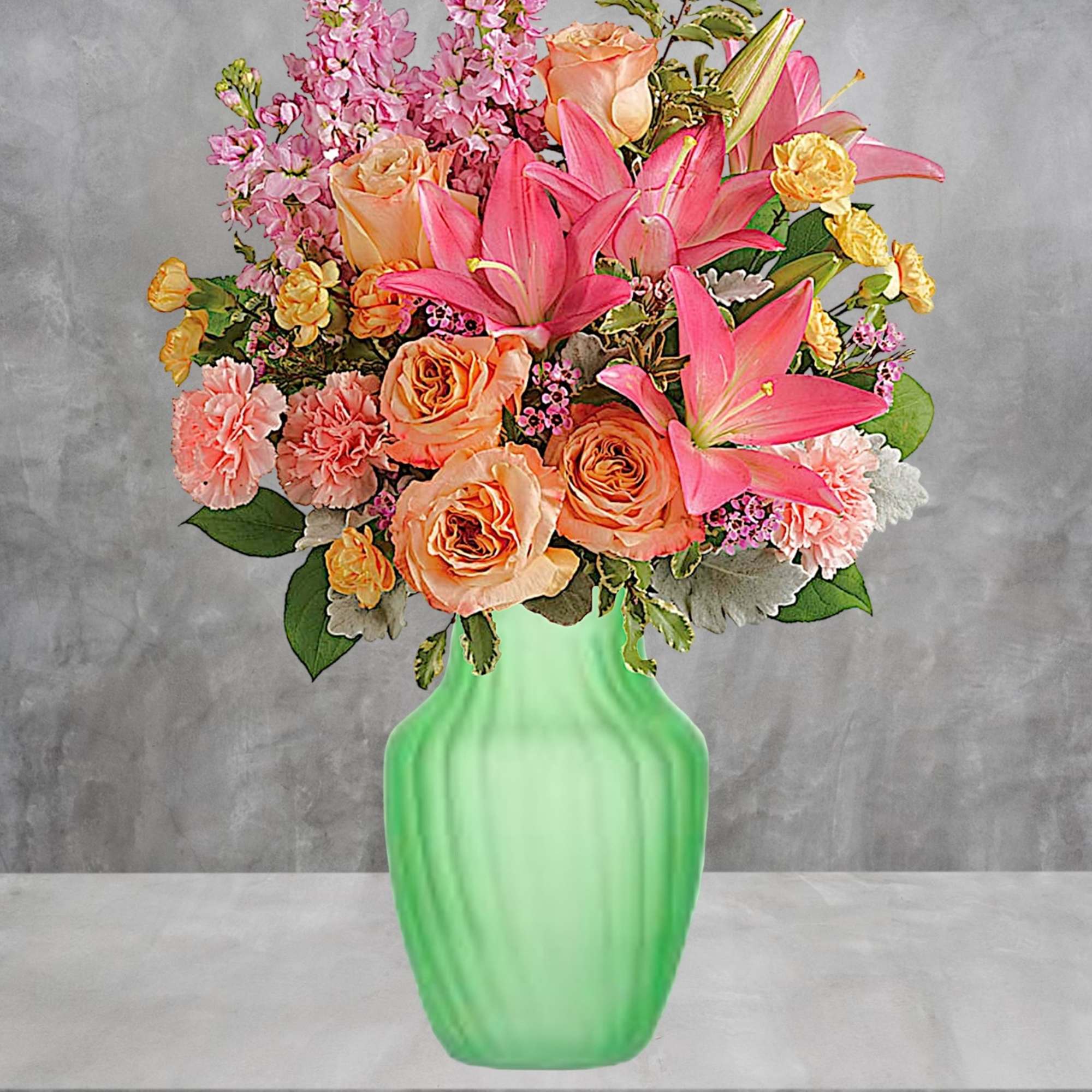 Pink and peach floral arrangement in a green vase, photo 2 of 4
