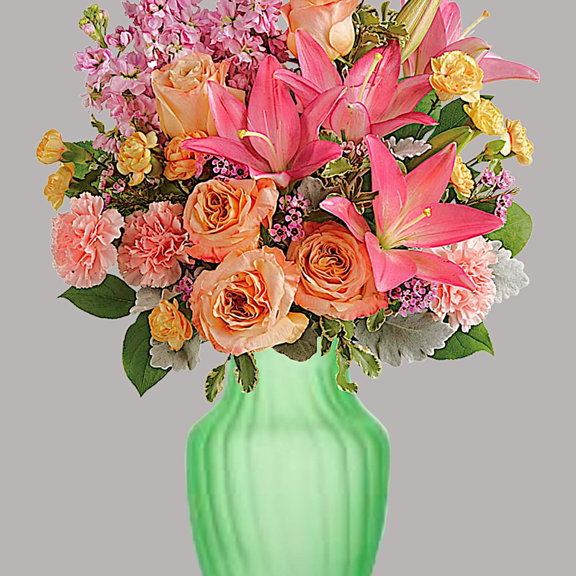 Bouquet of pink lilies and peach roses in a green vase