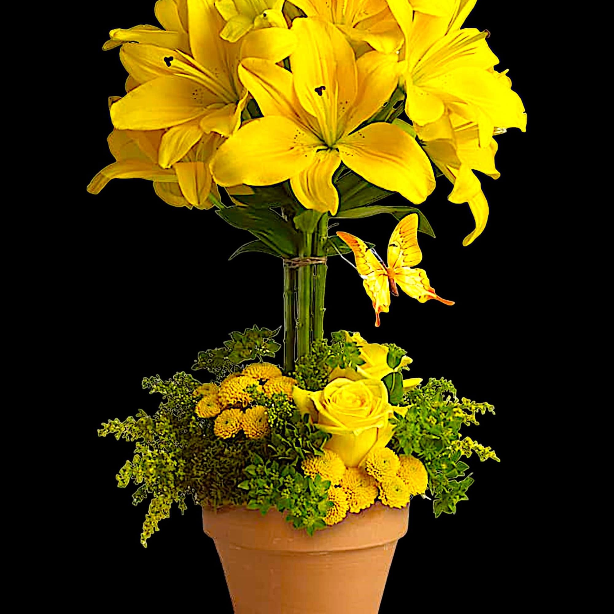 Yellow lilies and roses arranged in a terracotta pot with a butterfly accent