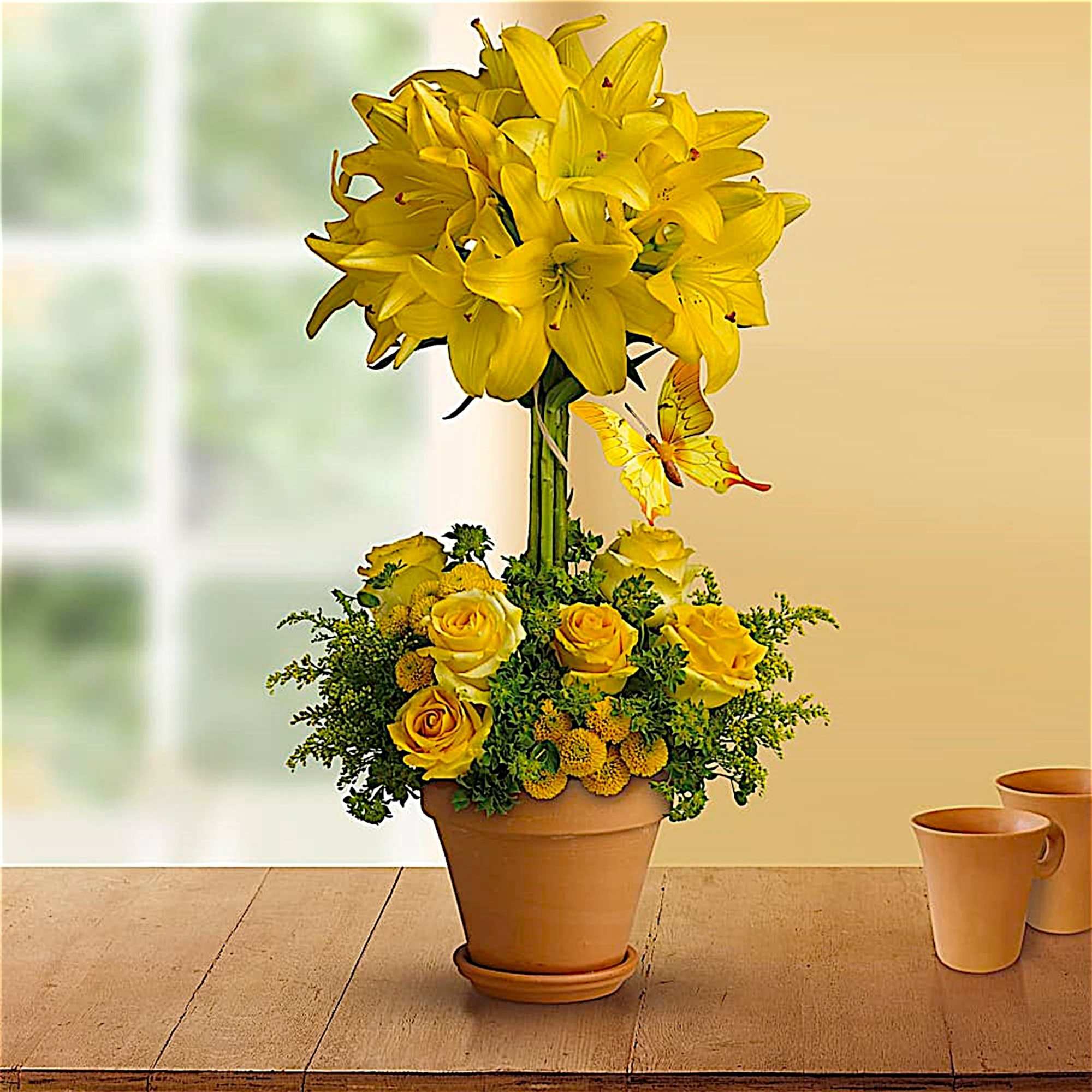Yellow lilies and roses arranged in a terracotta pot, photo 2 of 5