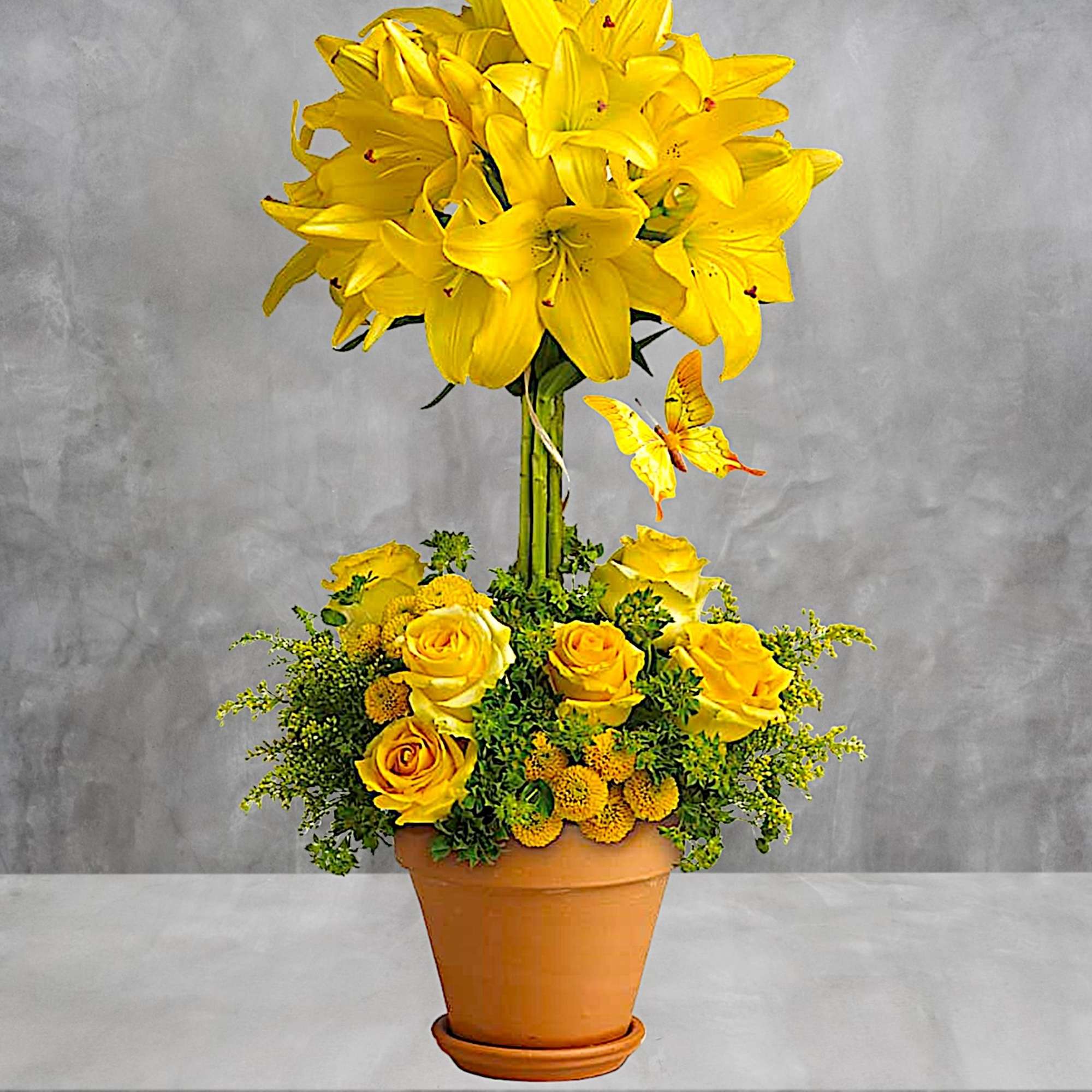 Yellow lilies and roses arranged in a terracotta pot, photo 3 of 5