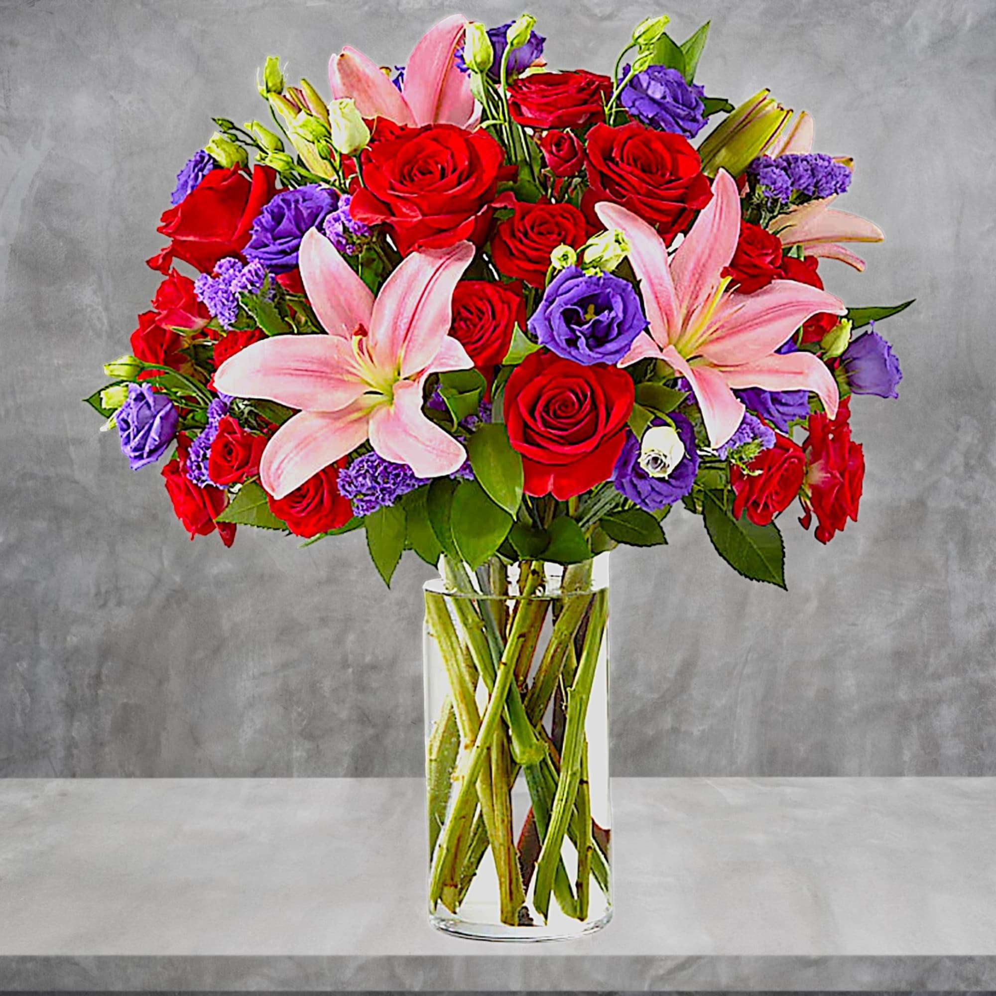 Bouquet of red roses and pink lilies in a clear glass vase, photo 3 of 6