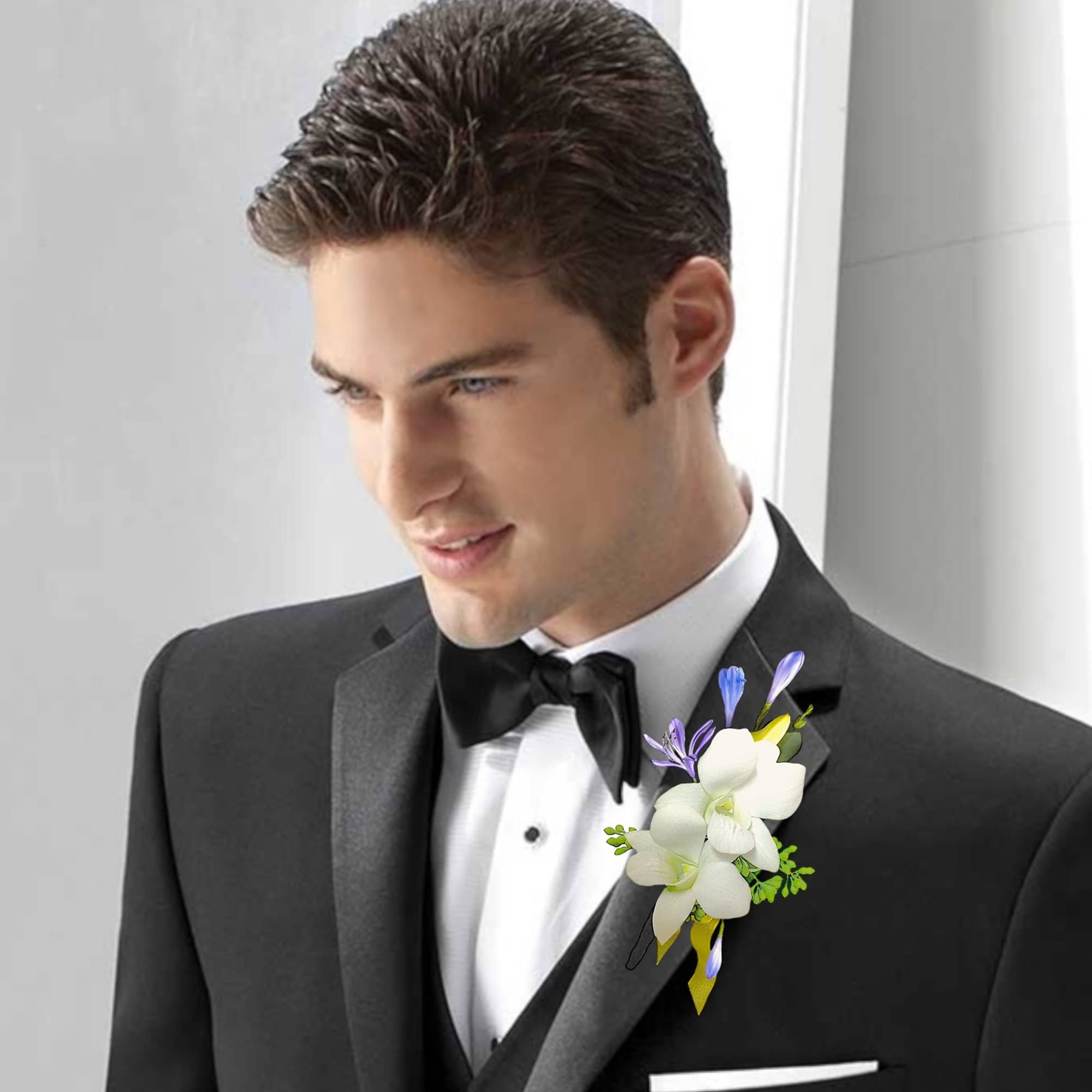 White orchid boutonniere on a black tuxedo lapel, photo 4 of 6