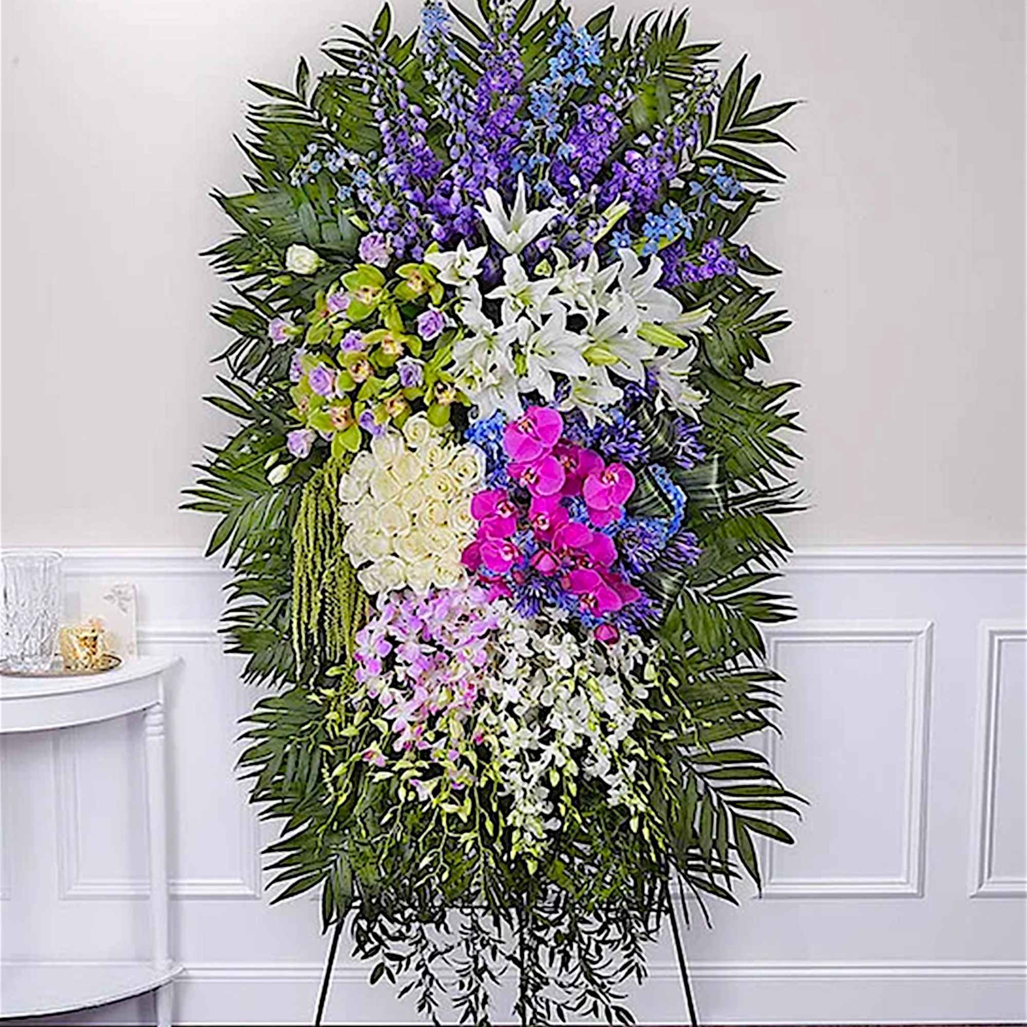 Tall standing spray with white lilies, orchids, and purple-blue flowers