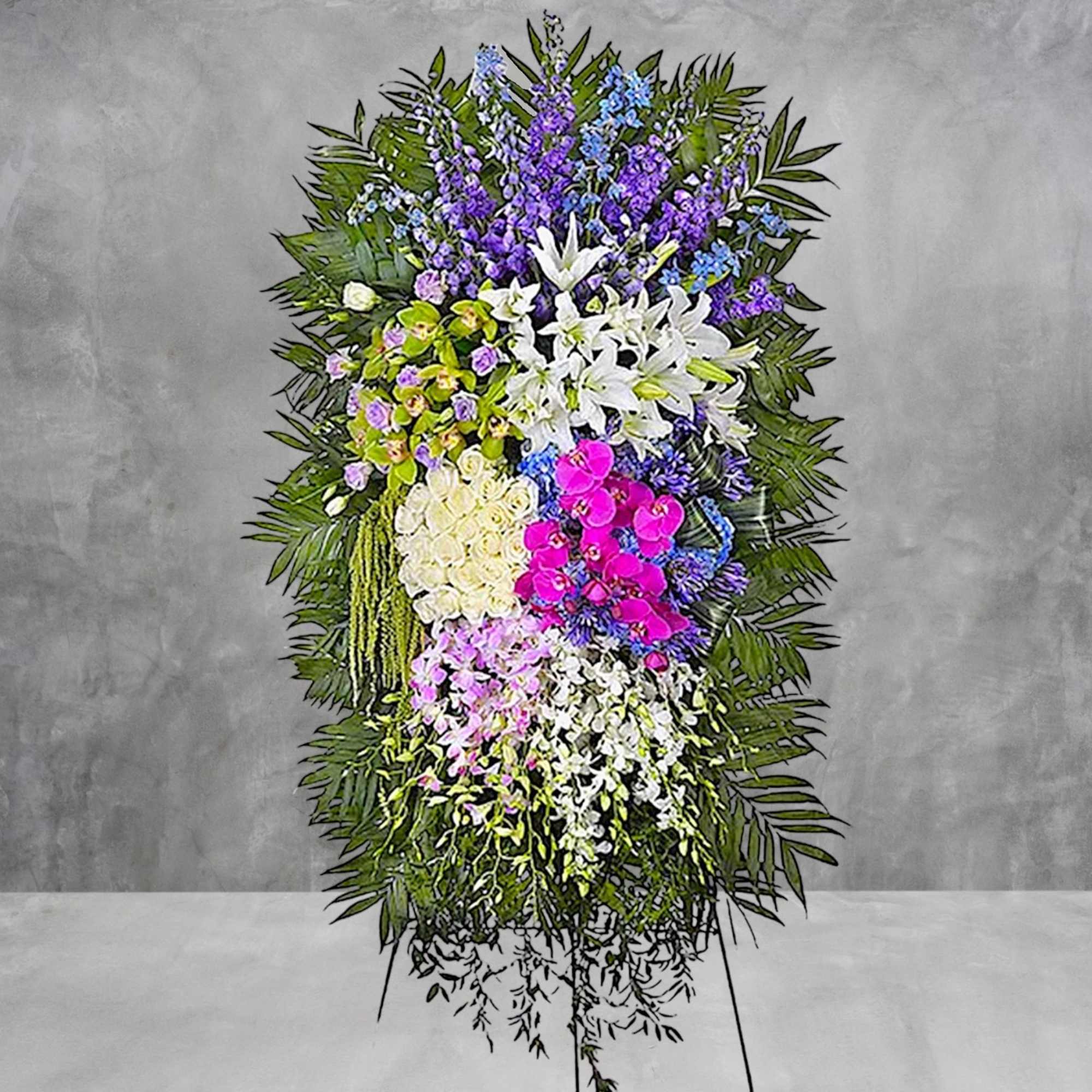 Tall standing floral spray with white lilies, orchids, and purple flowers
