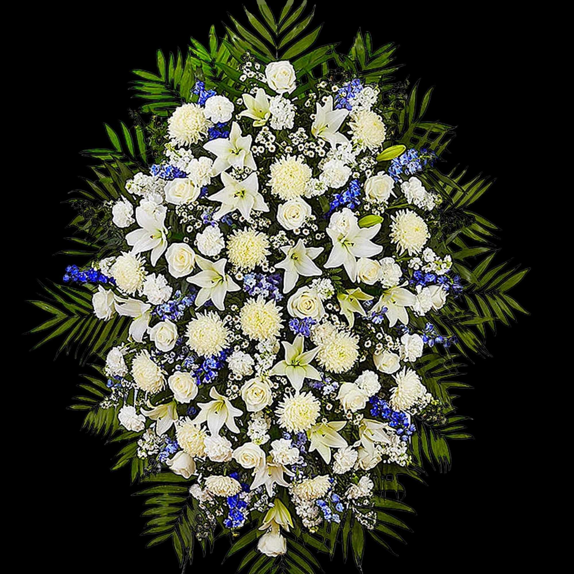 White floral standing spray with blue accents and palm leaves