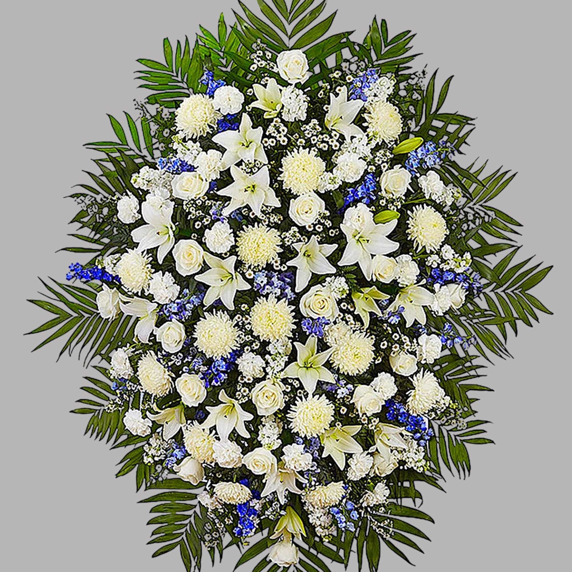 Large white funeral spray with lilies, roses, and blue accents, photo 5 of 5