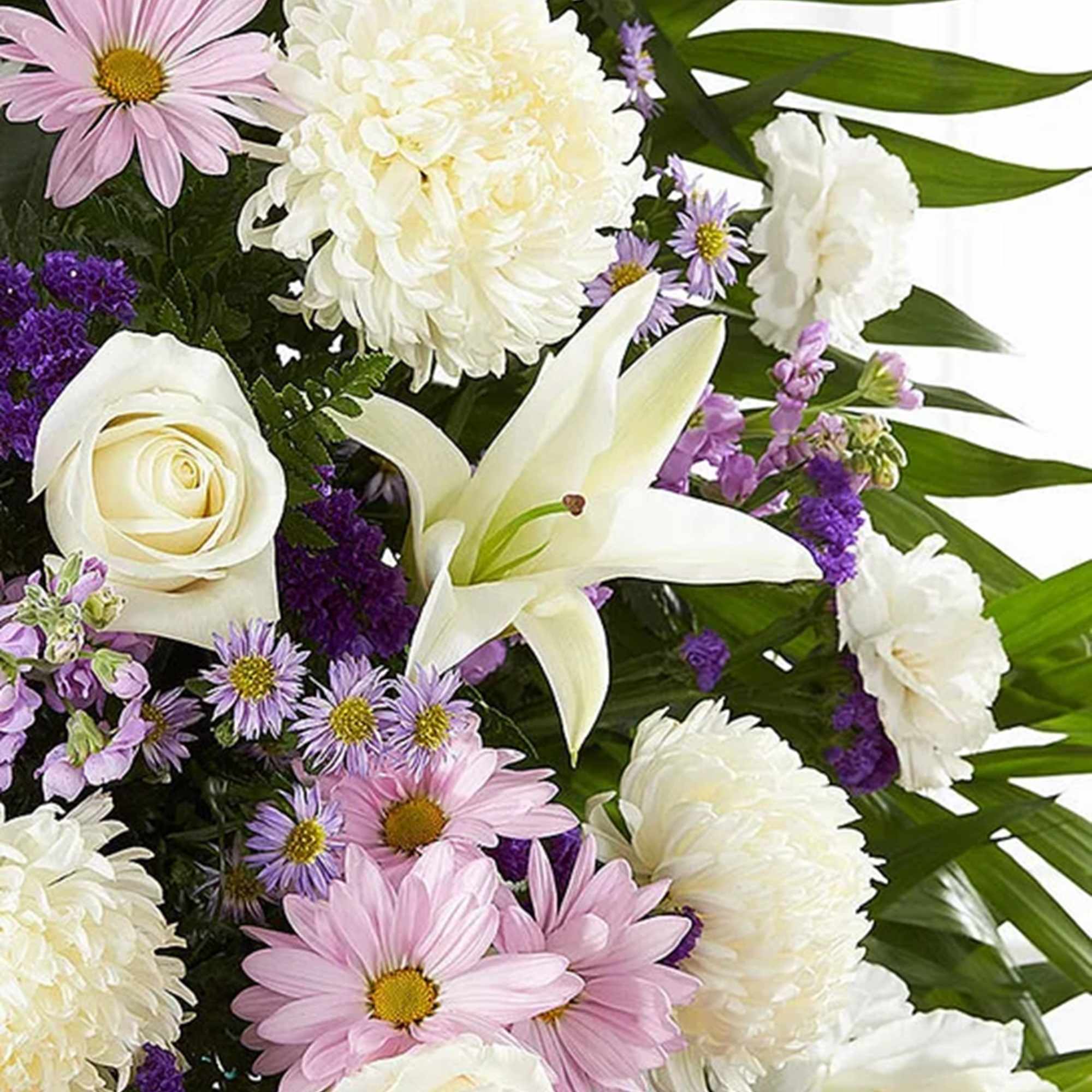 Bouquet of white lilies, roses, and pink daisies with purple accents