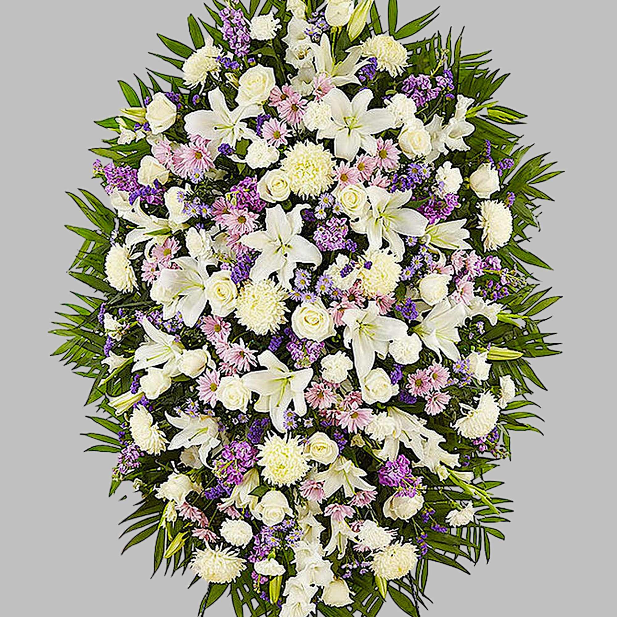 Large white and purple funeral spray with lilies and roses