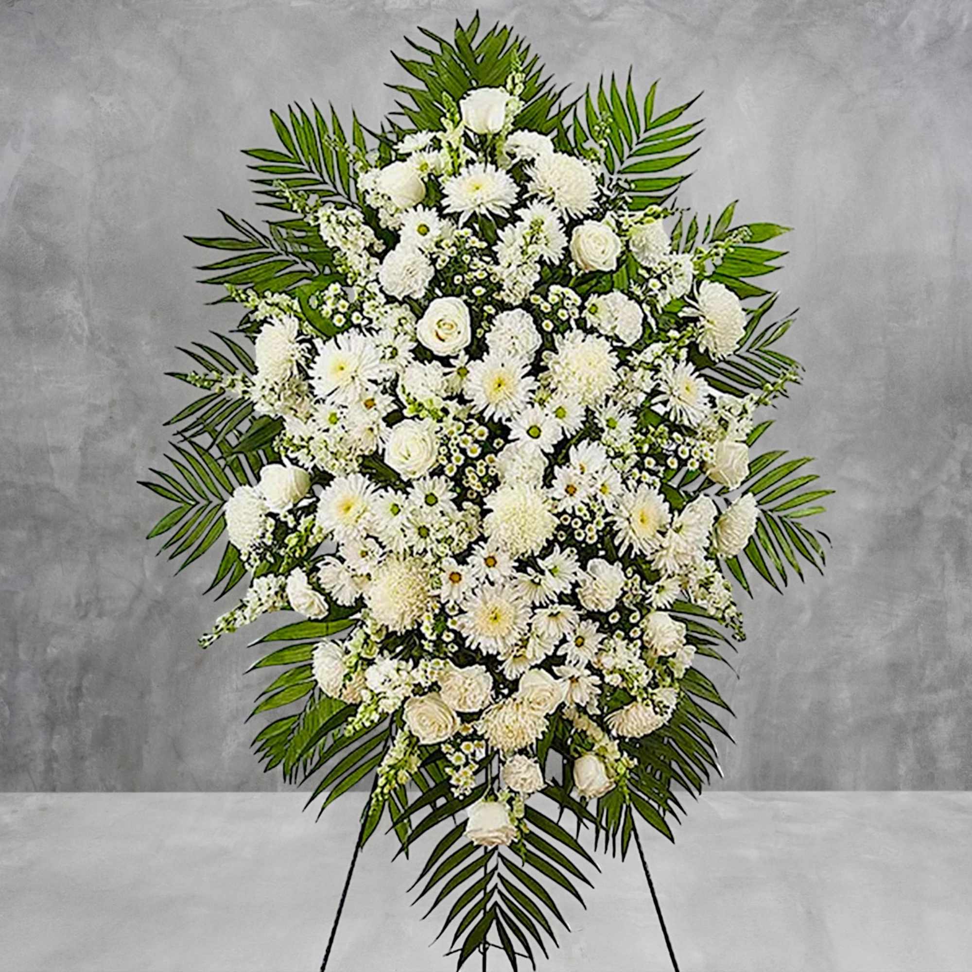 White funeral spray with roses and chrysanthemums on a stand