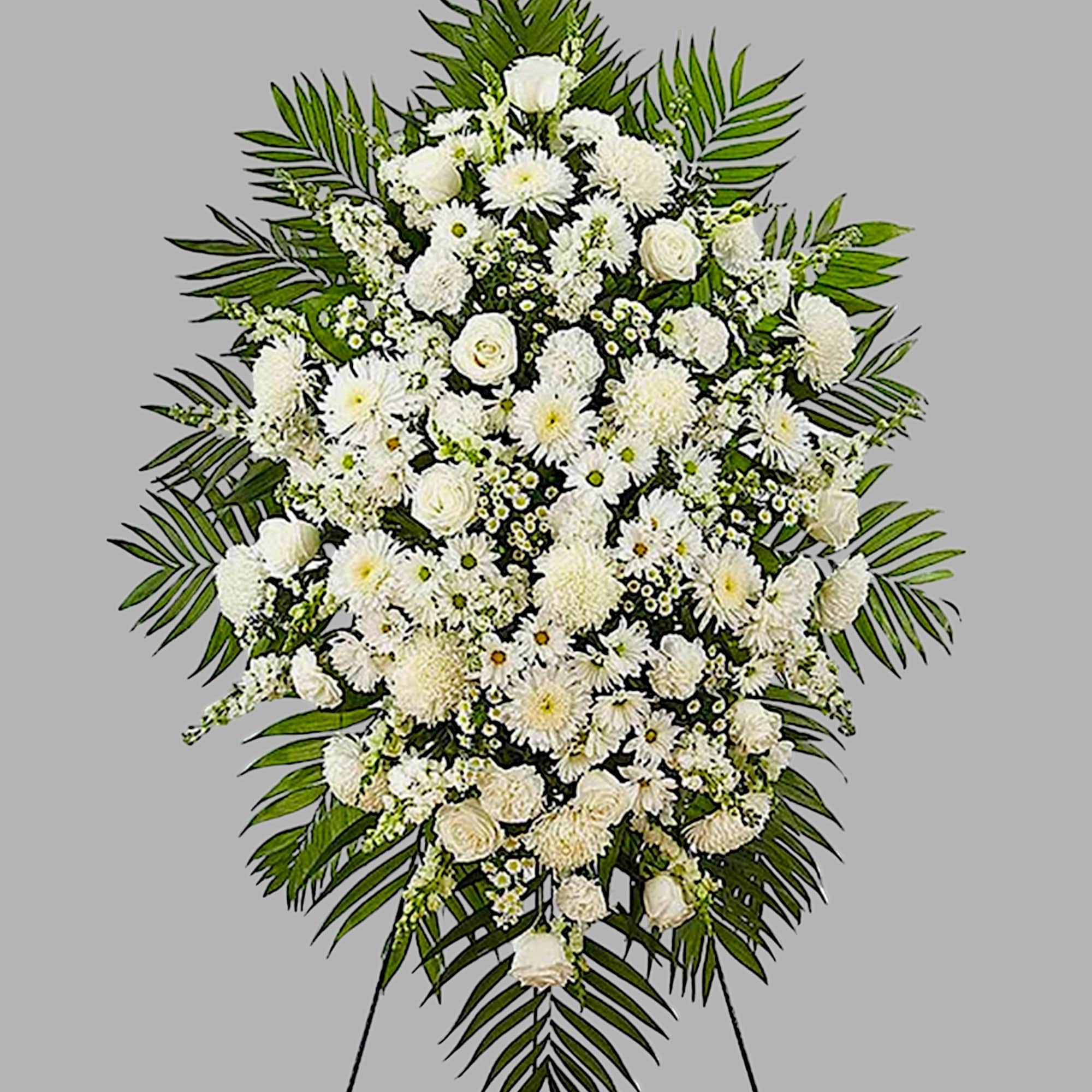 Large white funeral spray with roses and daisies on a standing easel