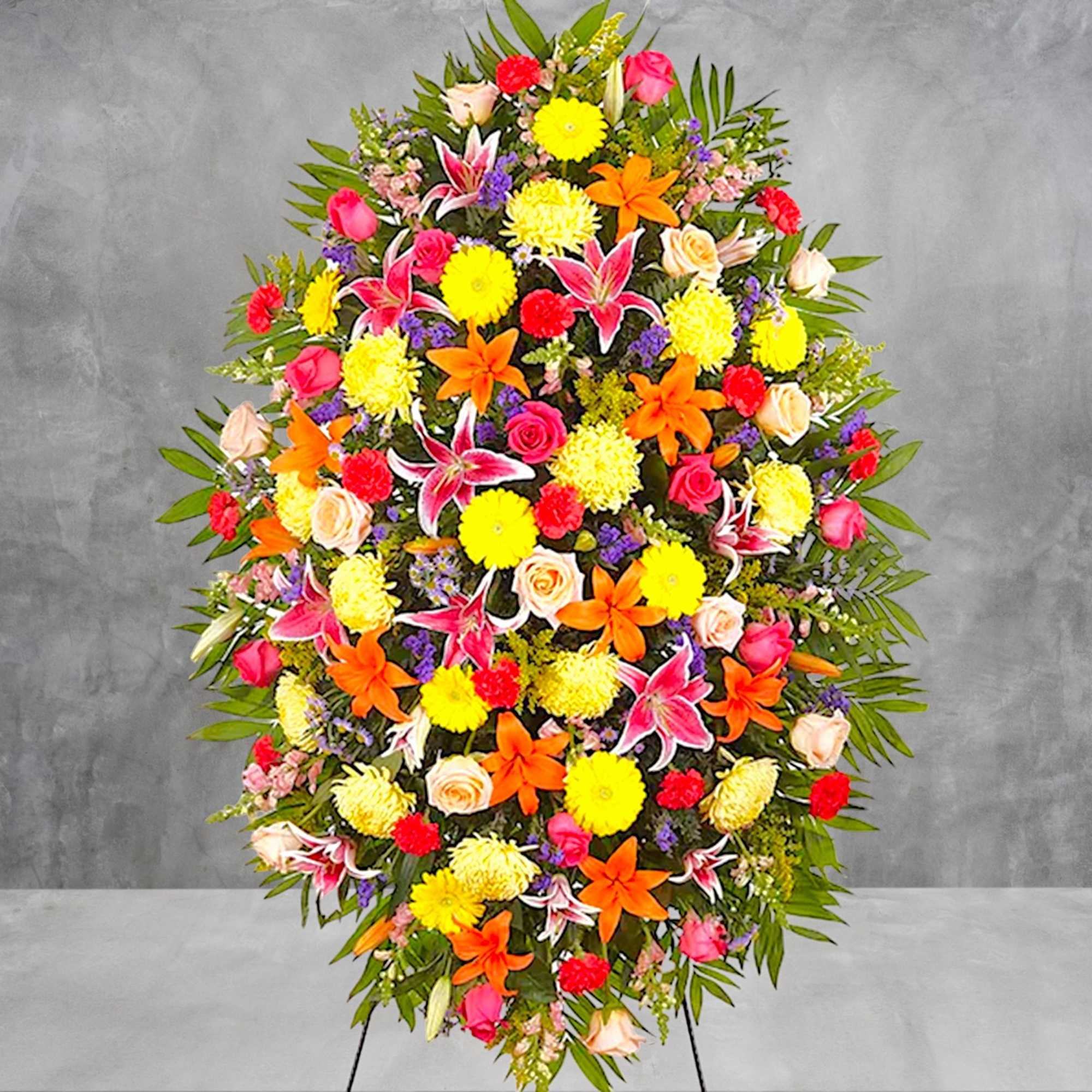 Large standing spray with lilies, roses, and mums in bright mixed colors