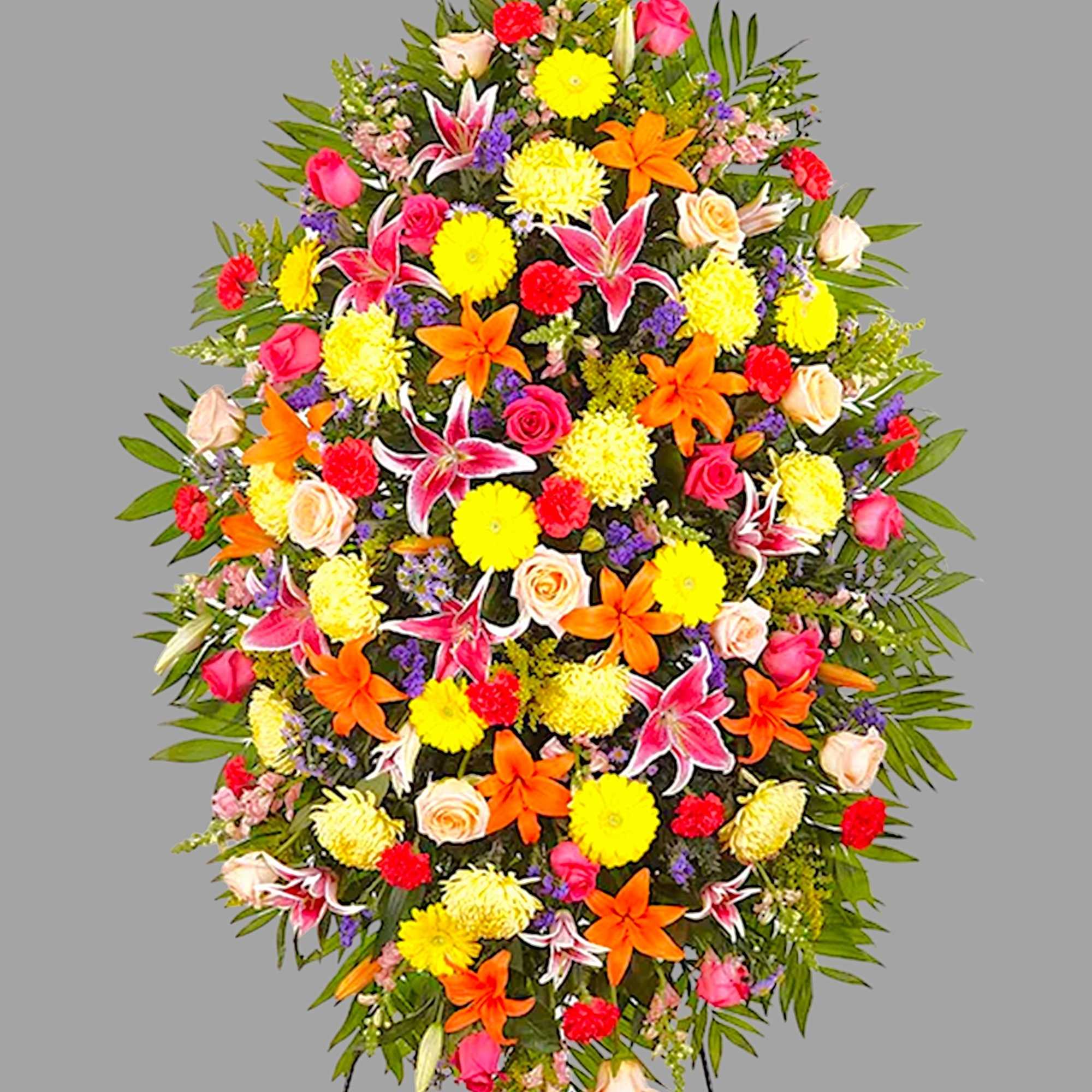 Large standing spray of mixed flowers in bright pink, yellow, orange, and white