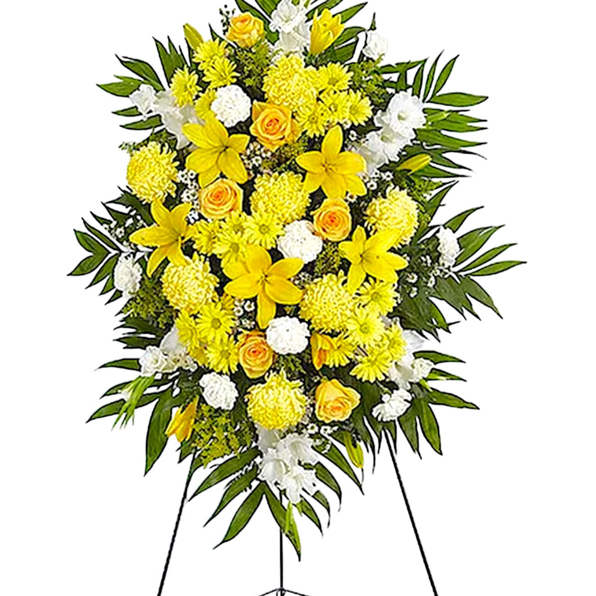 Yellow and white funeral spray on a standing easel