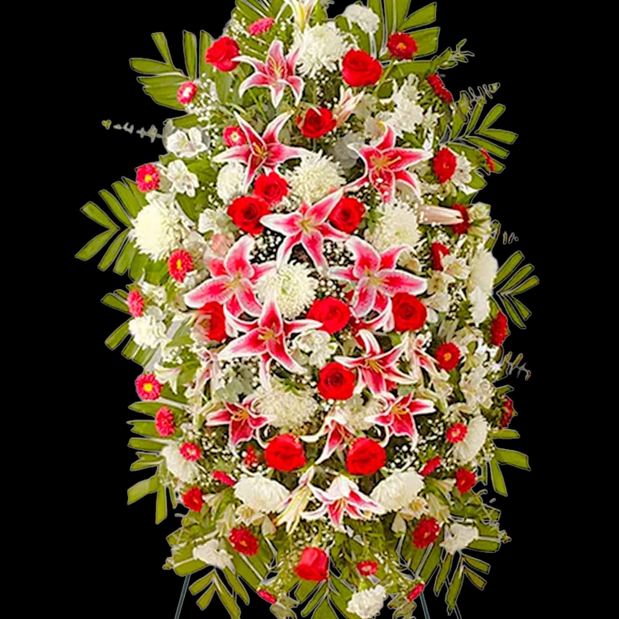 Standing floral spray with red, white, and pink flowers on an easel