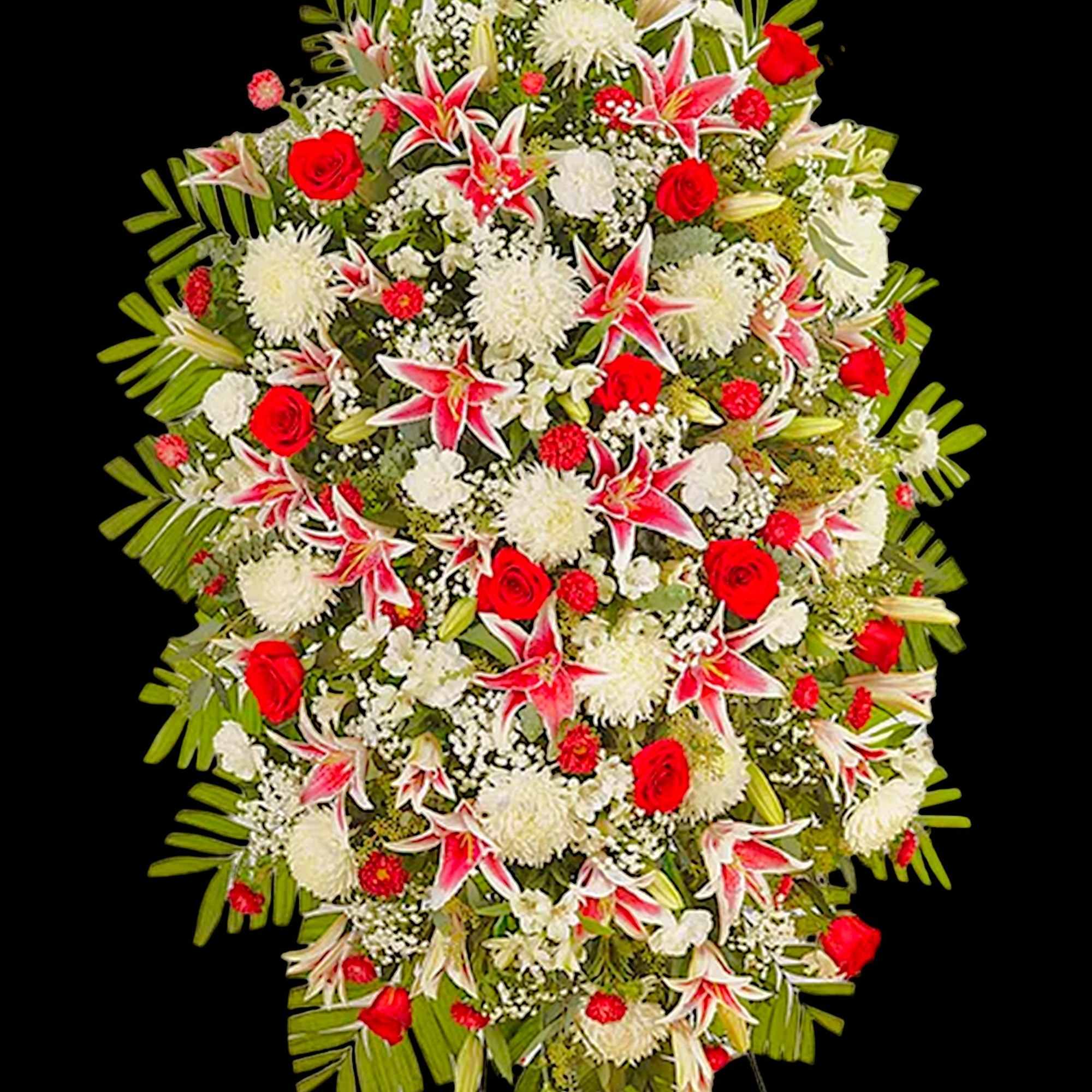 Standing floral spray with red roses and white lilies on a black background