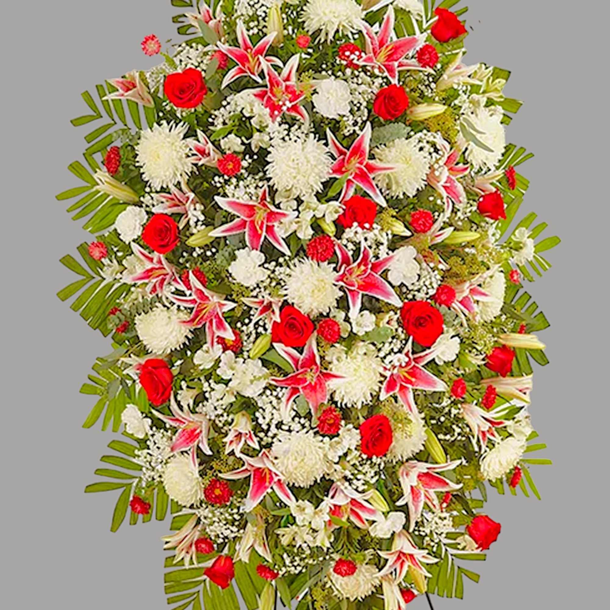 Large standing spray of red, white, and pink flowers