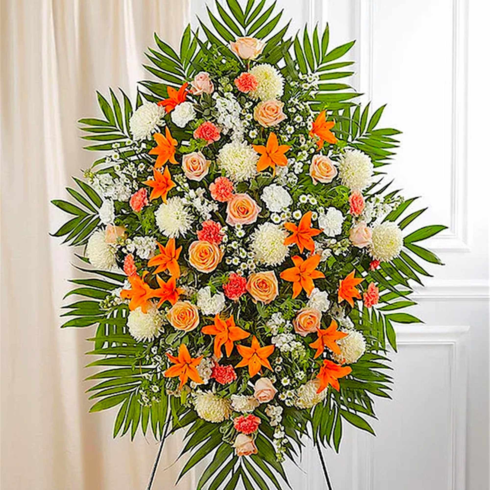 Large standing floral spray with orange lilies and peach roses