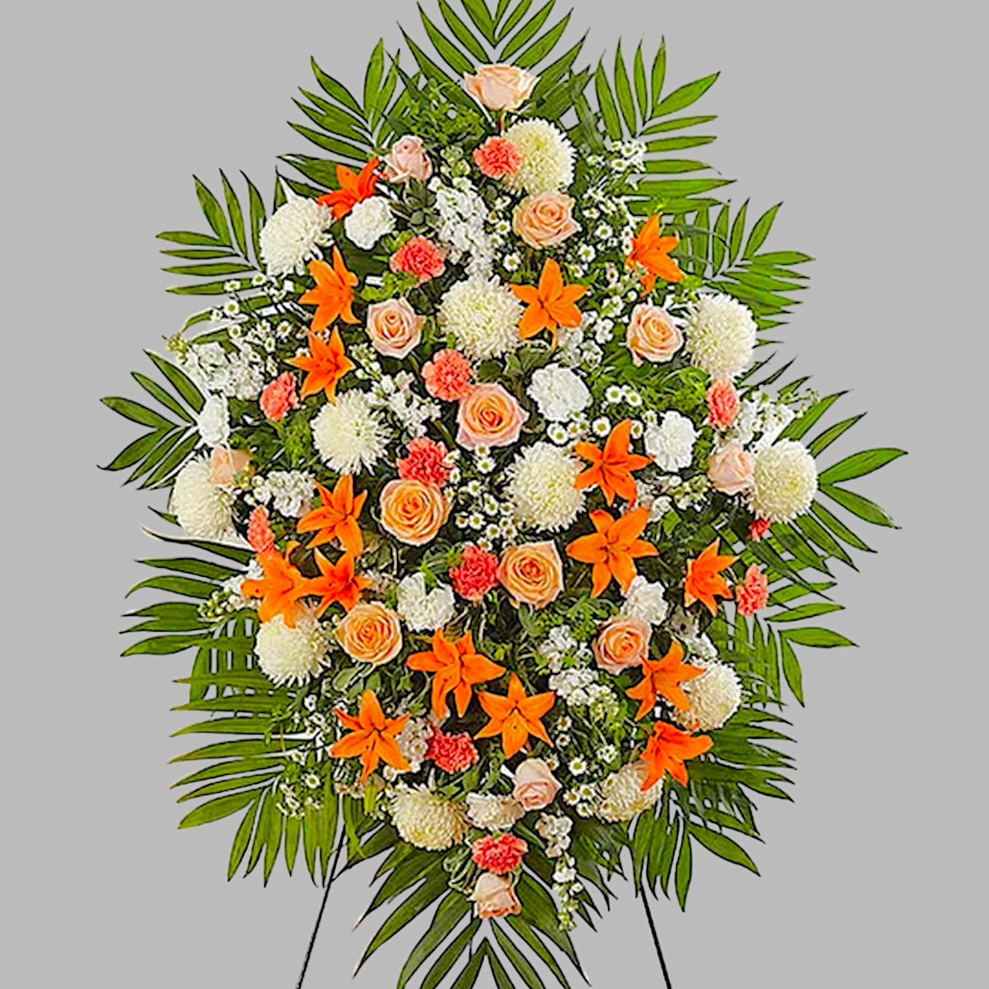 Standing floral spray with orange lilies, peach roses, and white blooms
