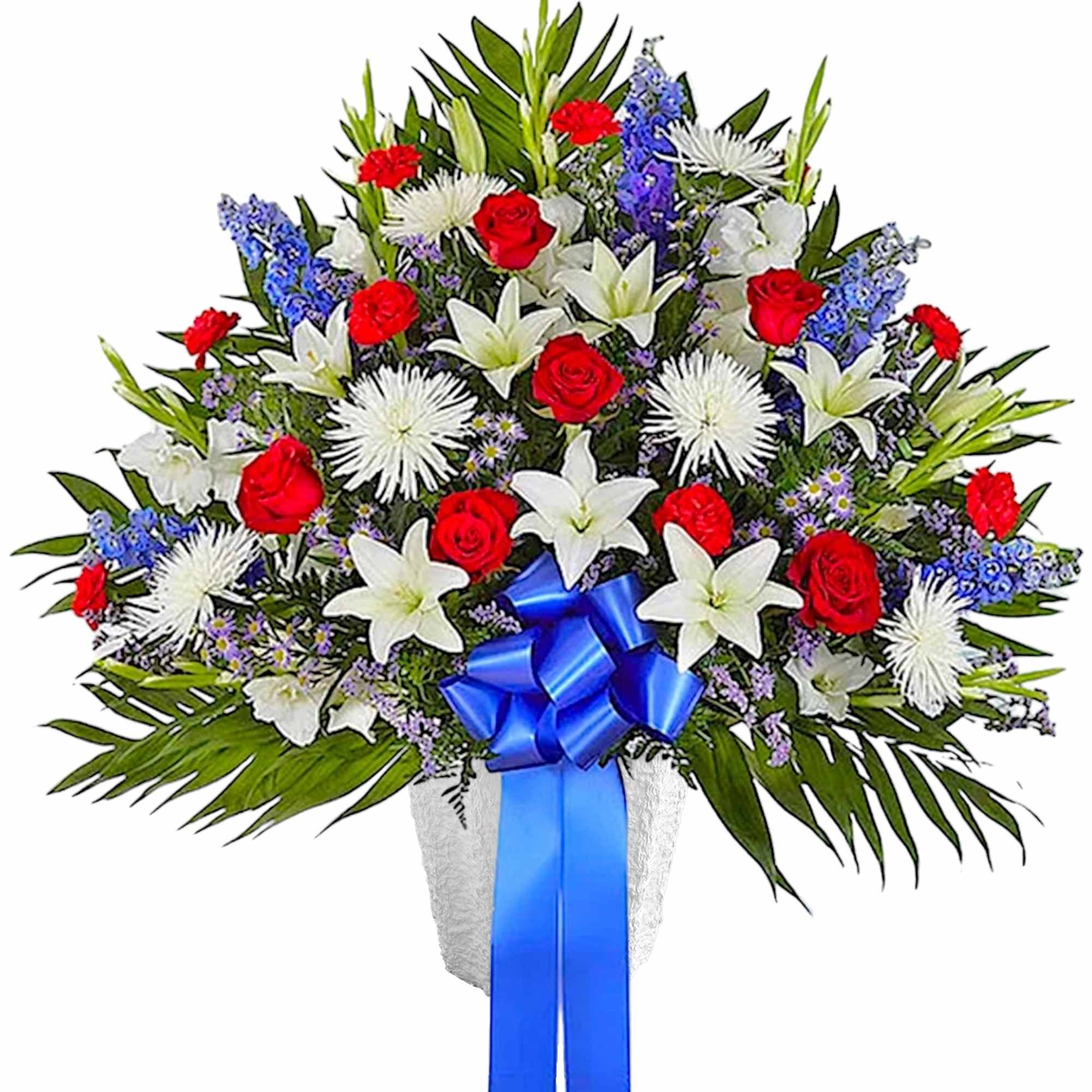 Large bouquet of red roses, white lilies, and blue flowers with a blue ribbon
