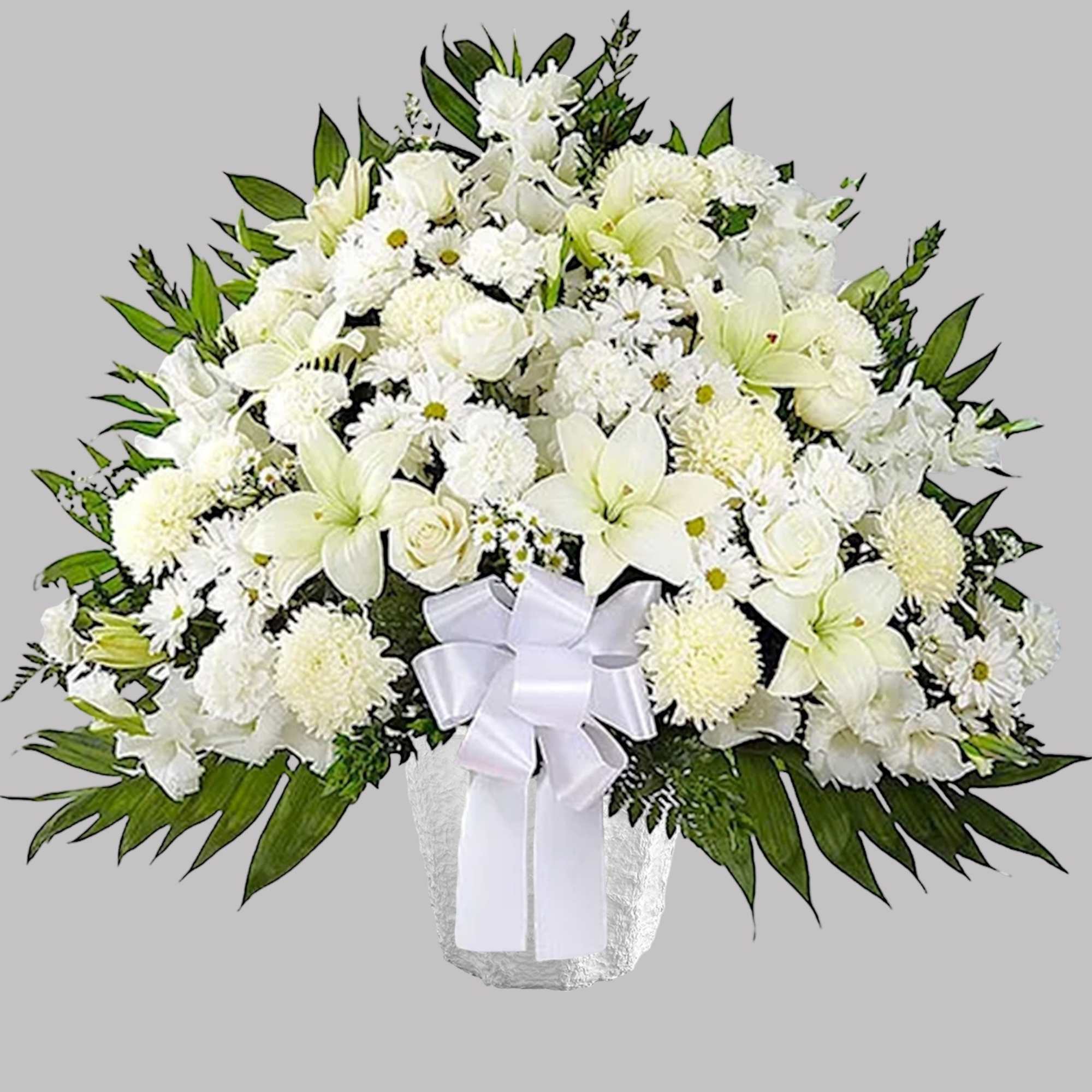 White floral arrangement in a vase with a white ribbon