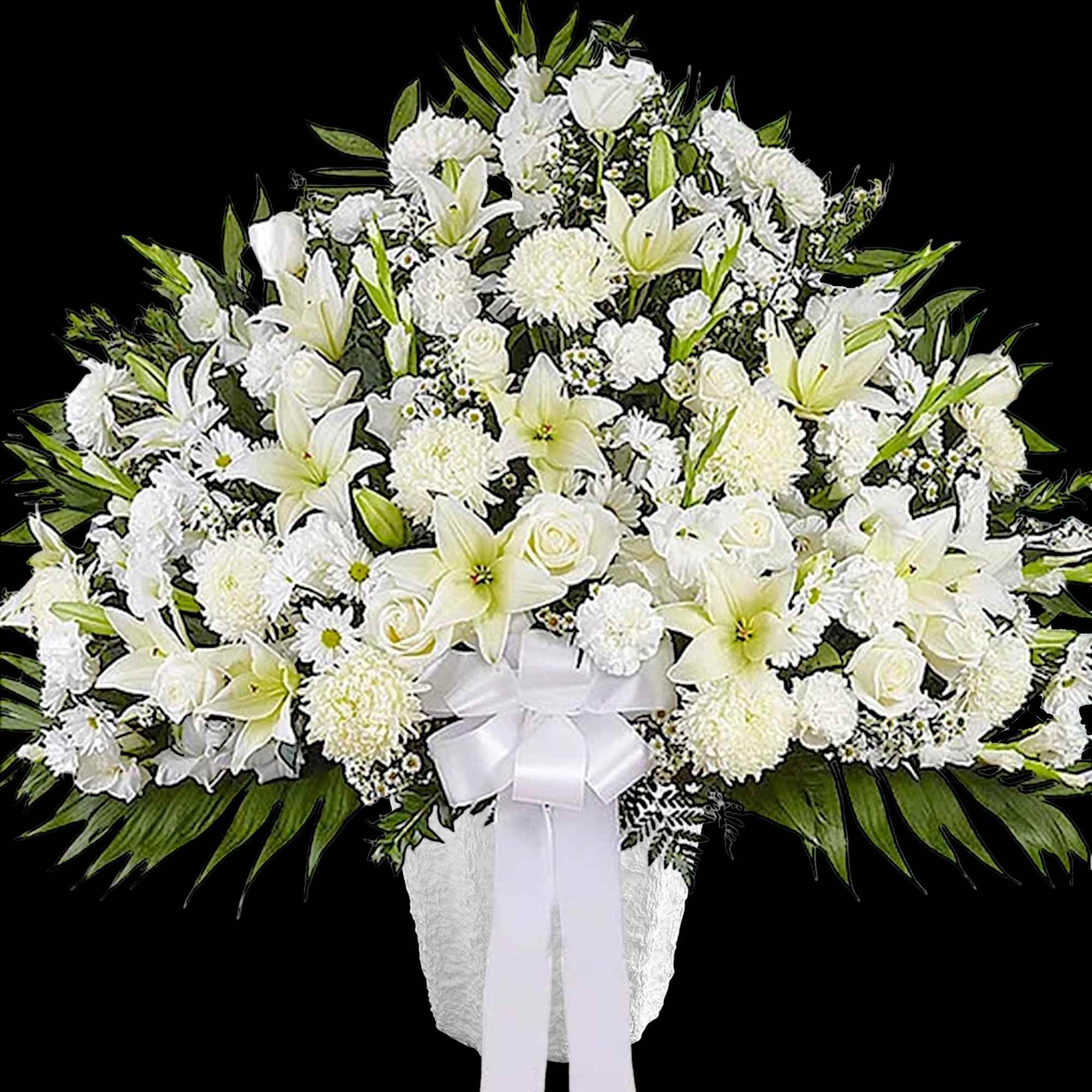White funeral spray with lilies, roses, and chrysanthemums in a white vase