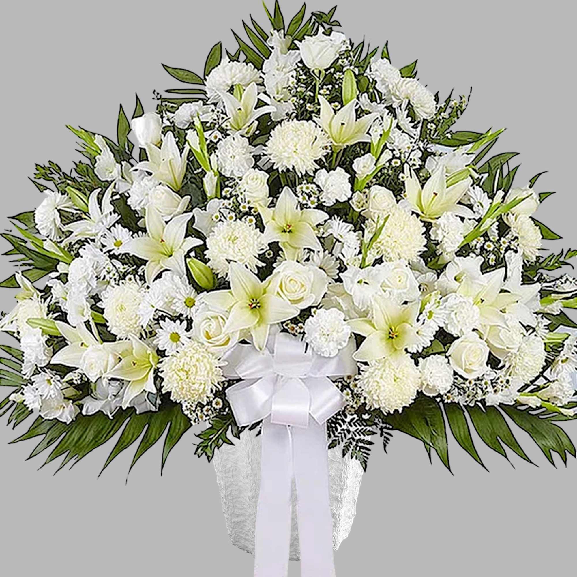 Large white funeral spray with lilies, roses, and chrysanthemums