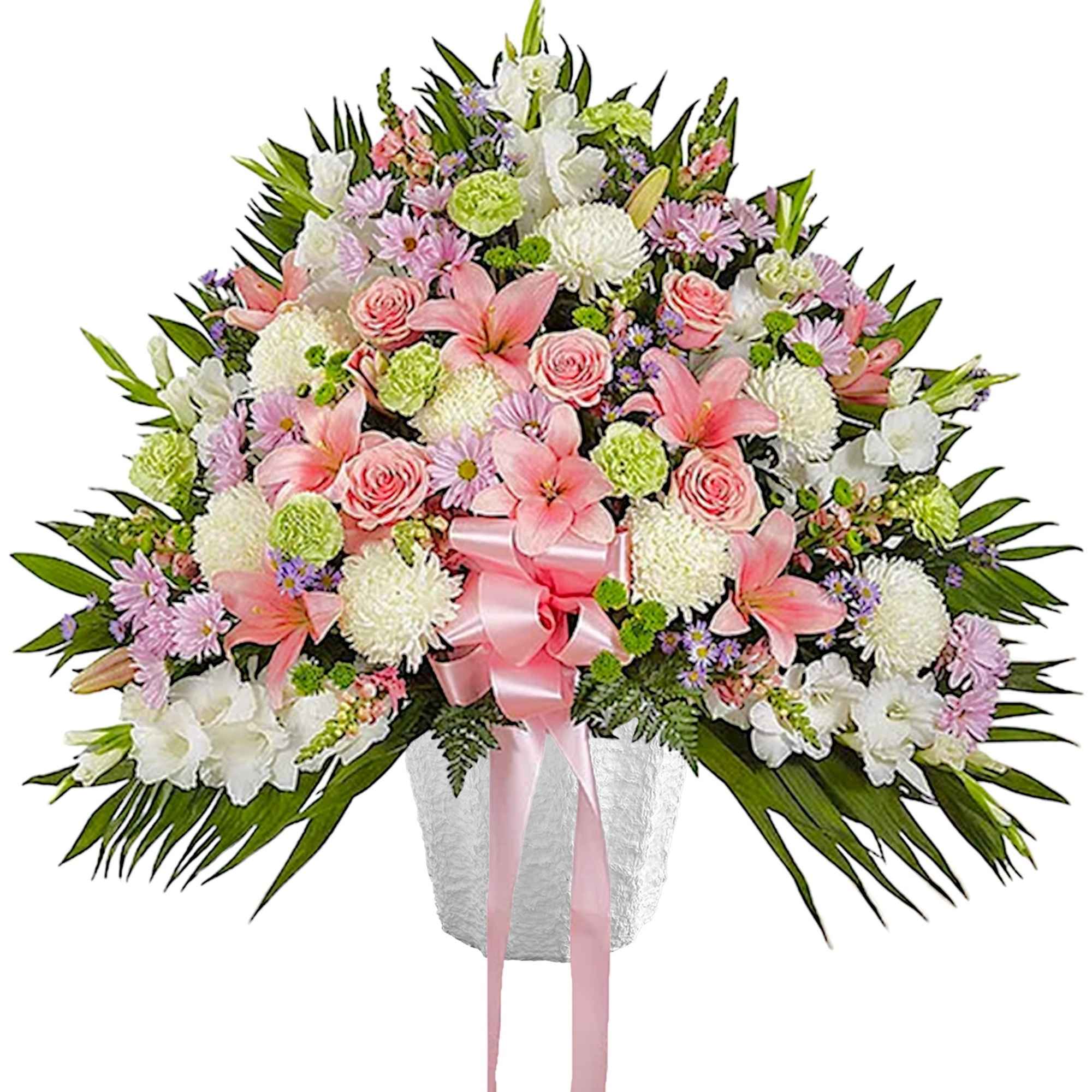 Large pink and white floral spray in a white vase with a pink ribbon
