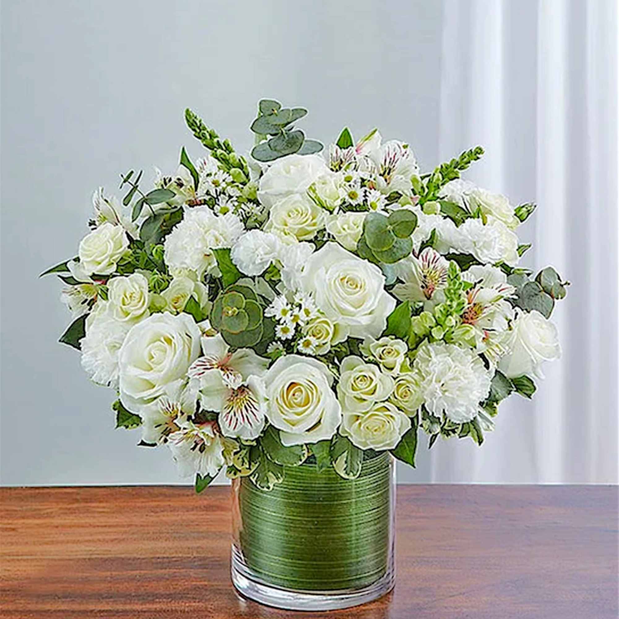 White rose bouquet in a green glass vase
