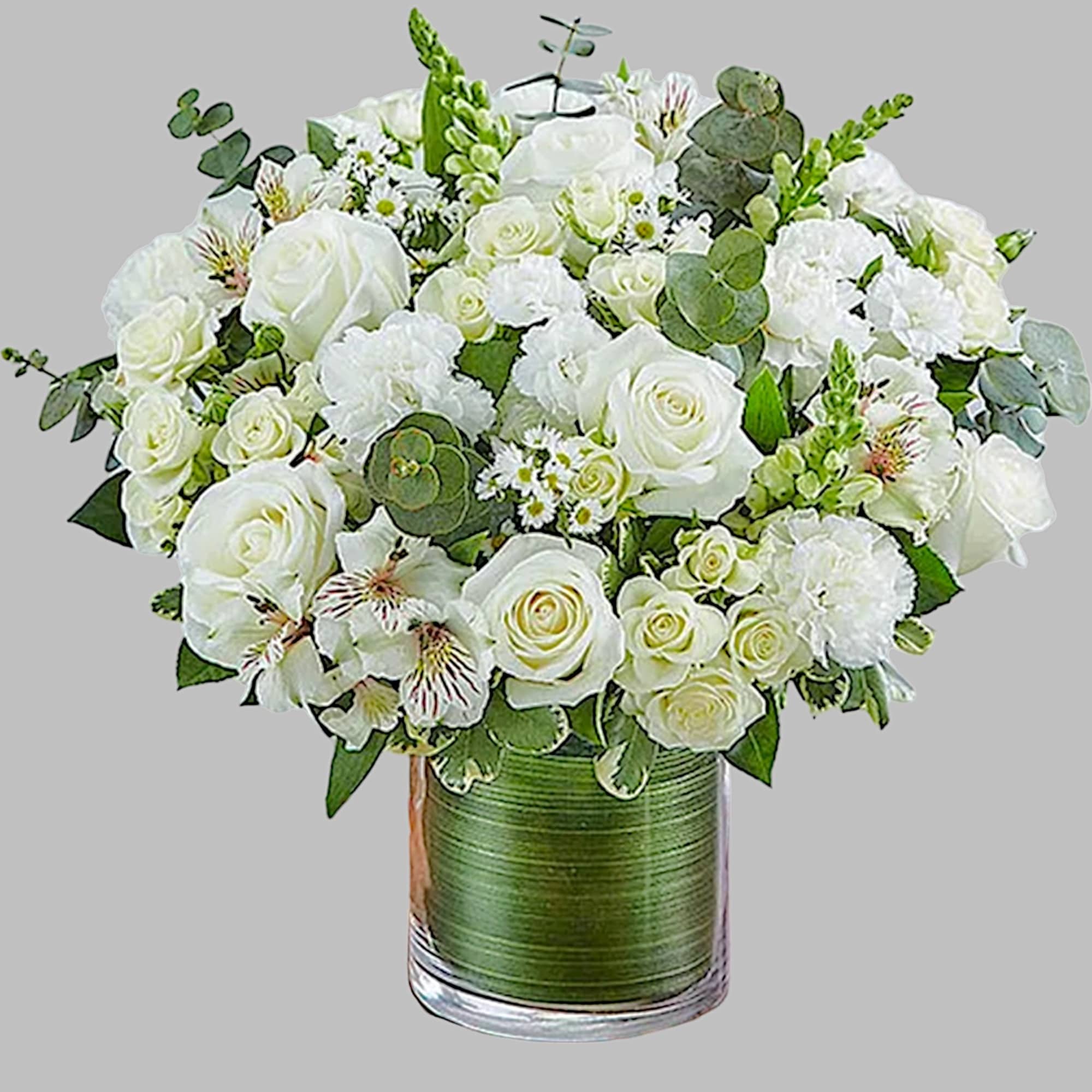 White rose bouquet in a glass vase with eucalyptus accents