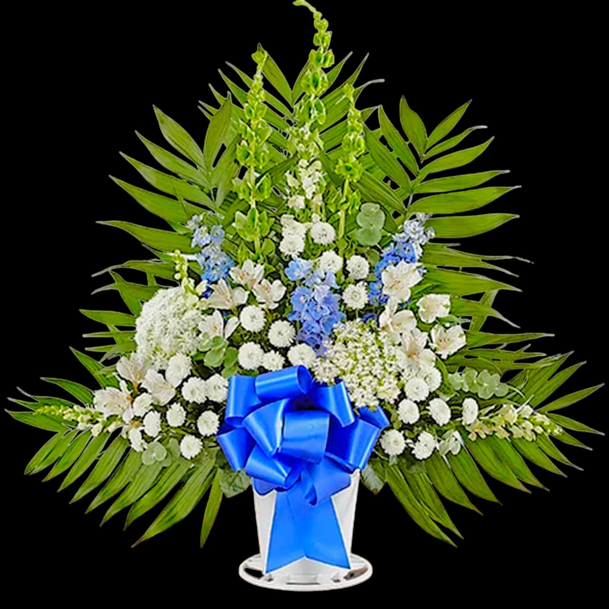 Standing floral spray with white and blue flowers and a blue ribbon on a white stand
