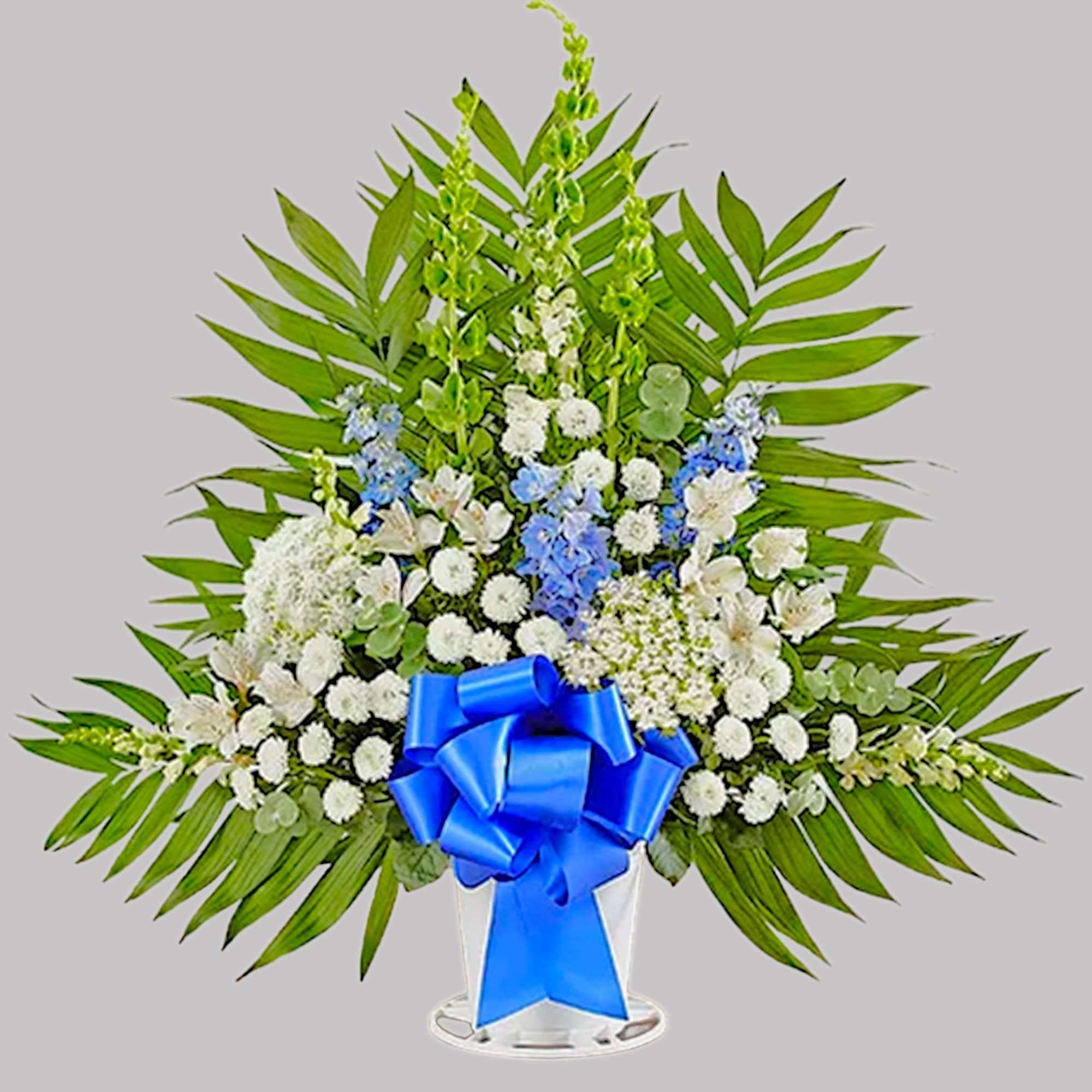 Standing floral spray with white and blue flowers and a blue ribbon