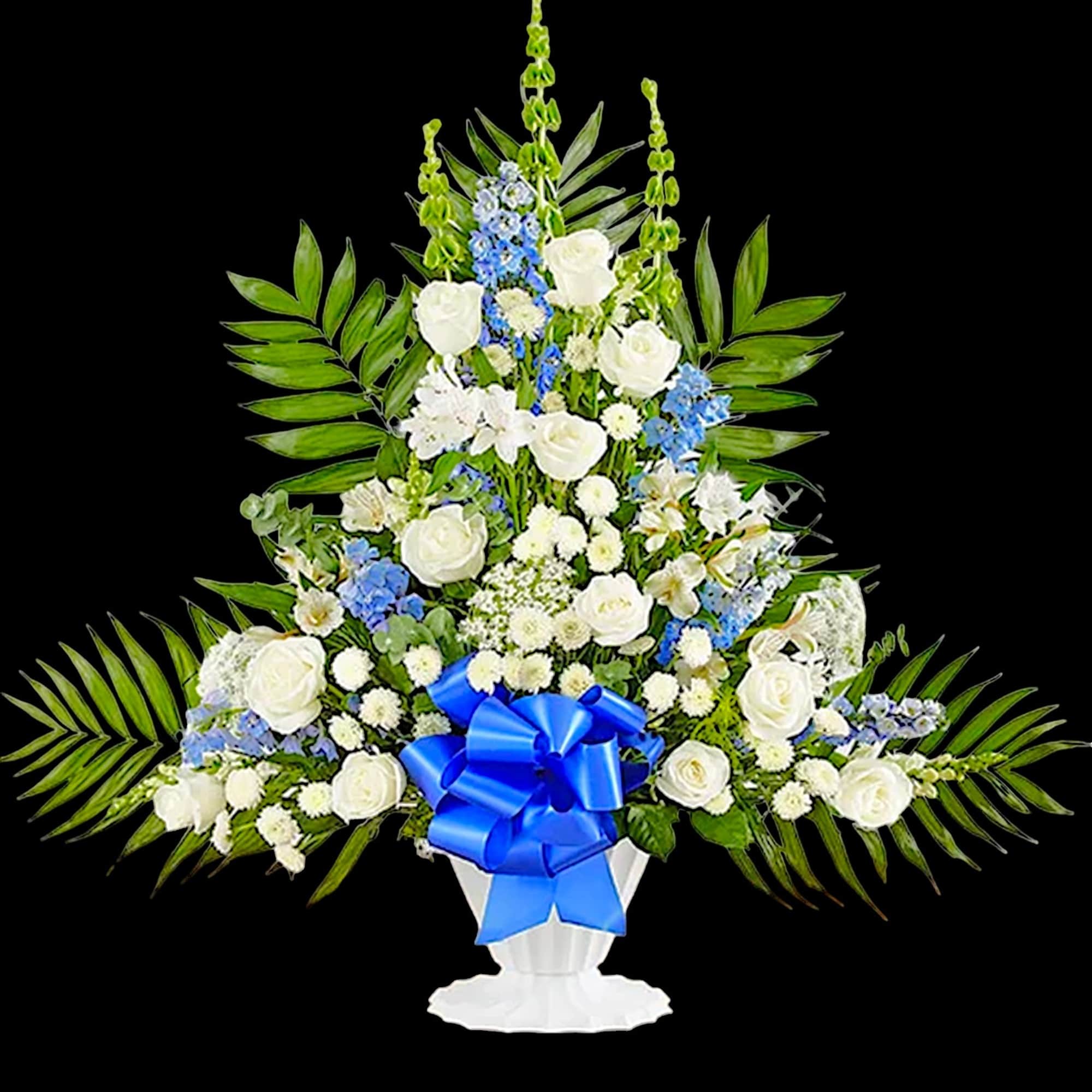 White and blue floral standing arrangement in a white pedestal vase with a blue ribbon