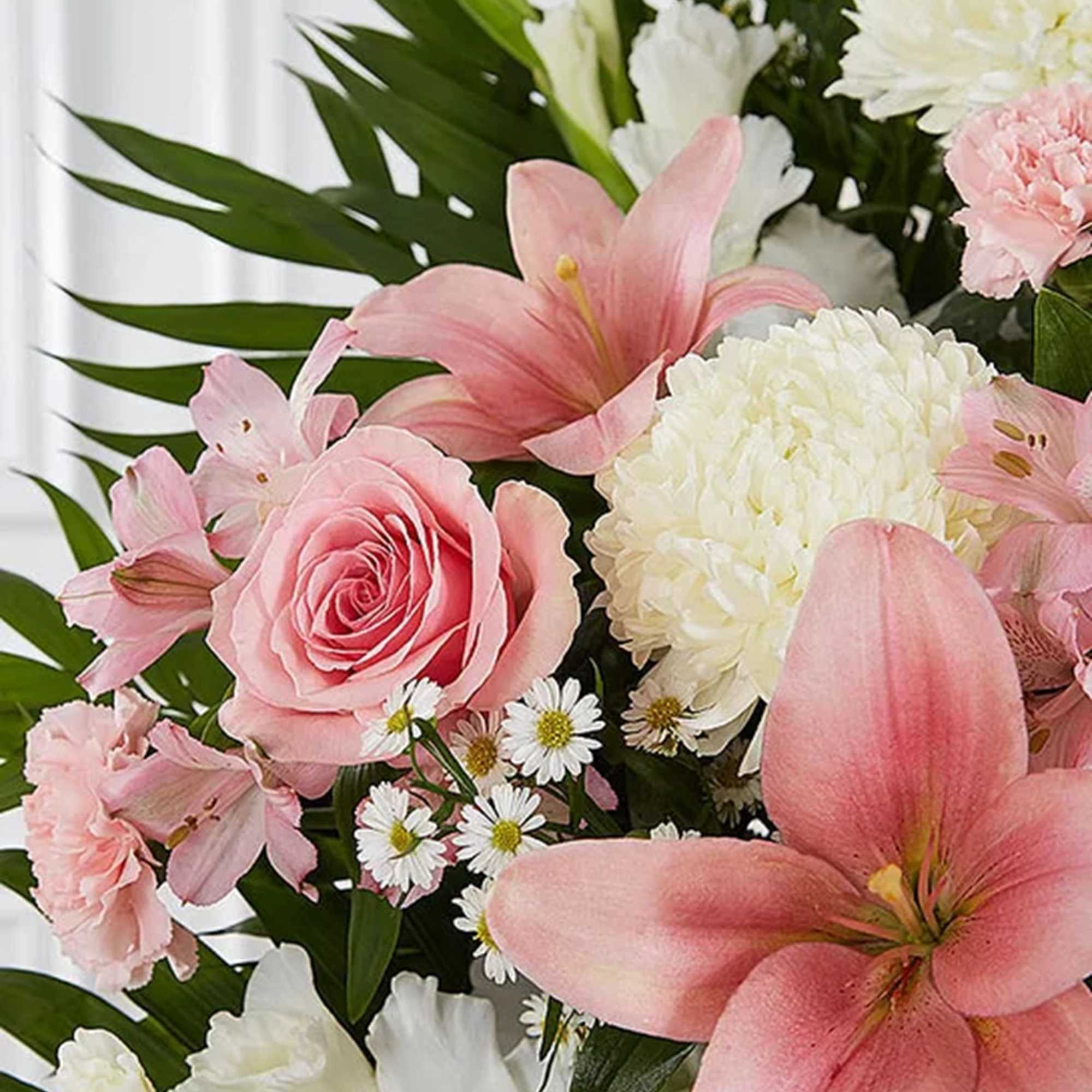 Pink lilies and roses with white chrysanthemums in a bouquet