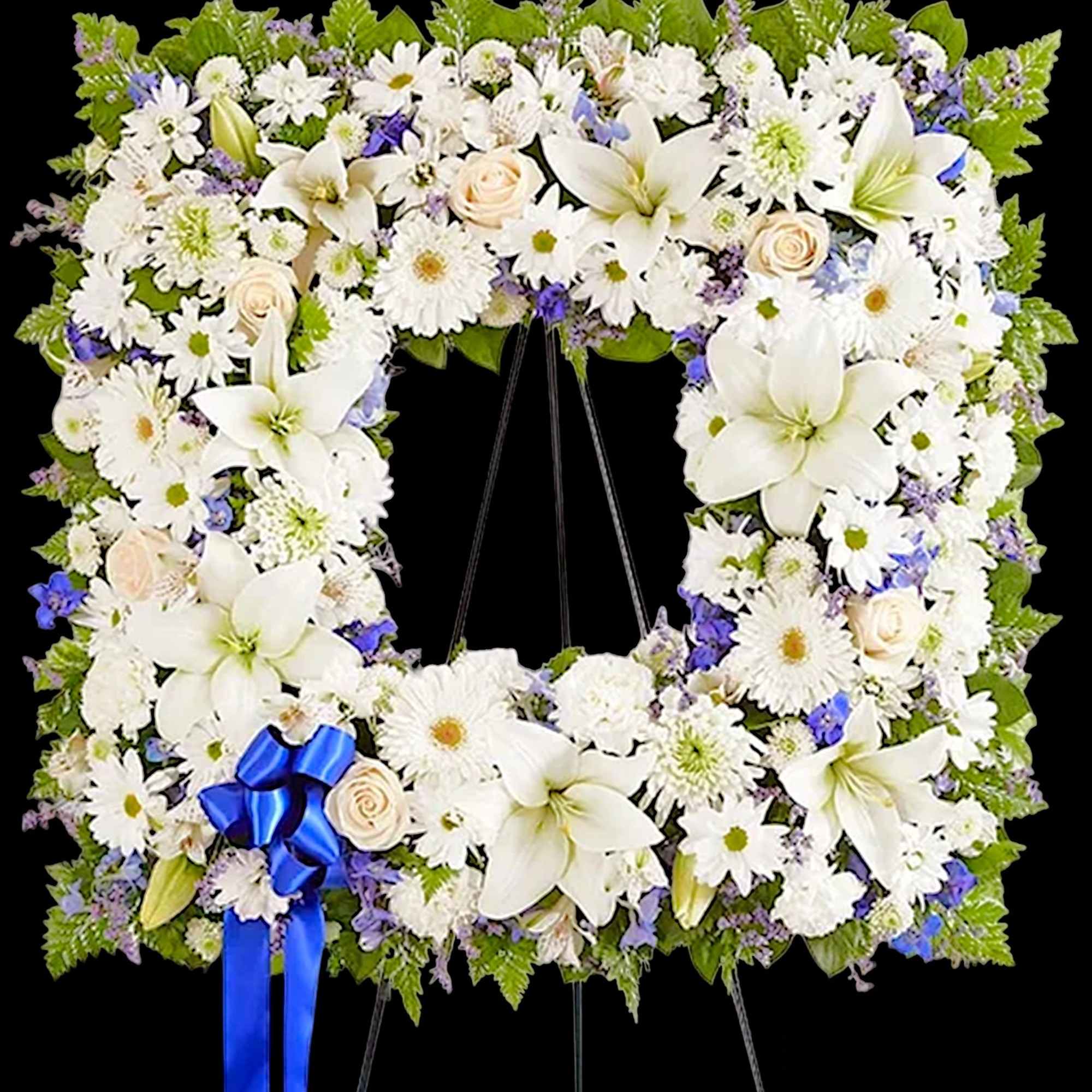 White floral funeral wreath with a blue ribbon on a stand