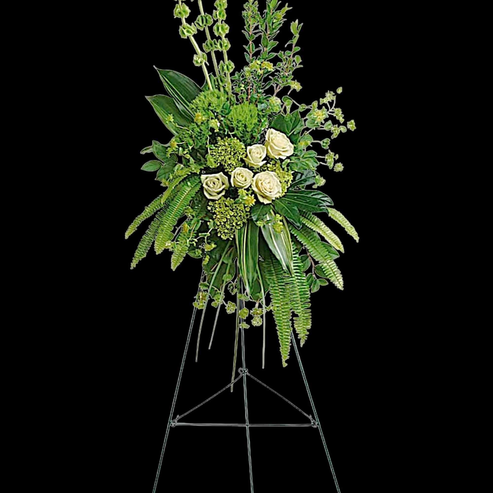 Tall white rose arrangement on a metal easel with cascading greenery