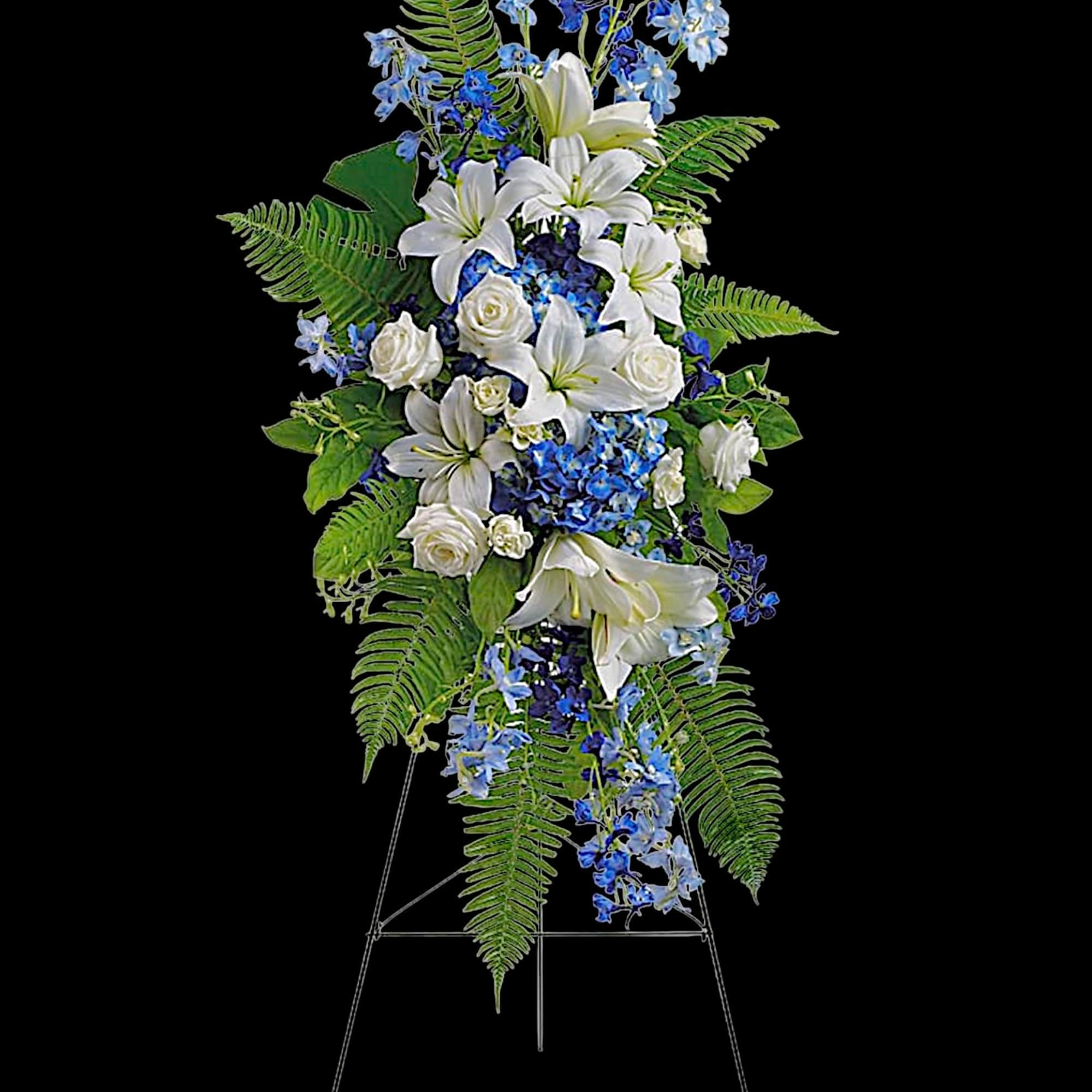 Tall white and blue floral standing spray on an easel