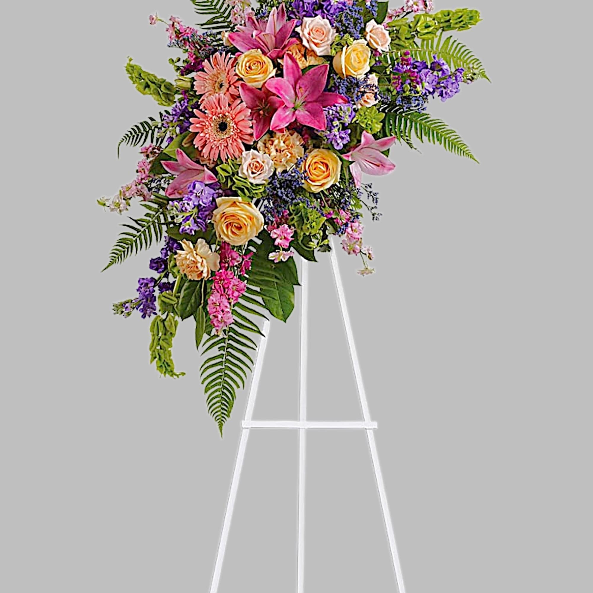 Share your feelings with this bountiful, cascading standing spray of feminine sympathy
