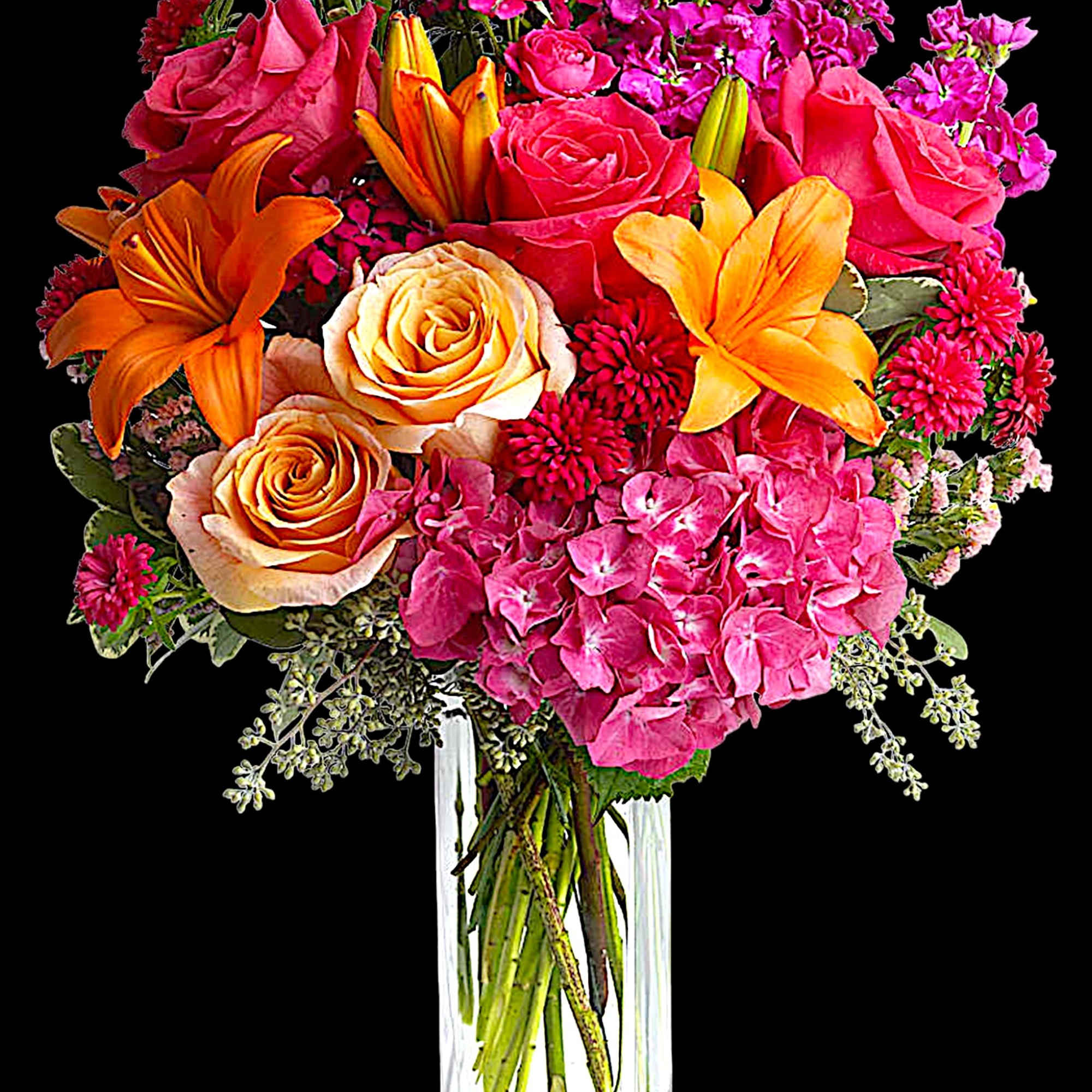 Bouquet of pink and orange flowers in a clear glass vase