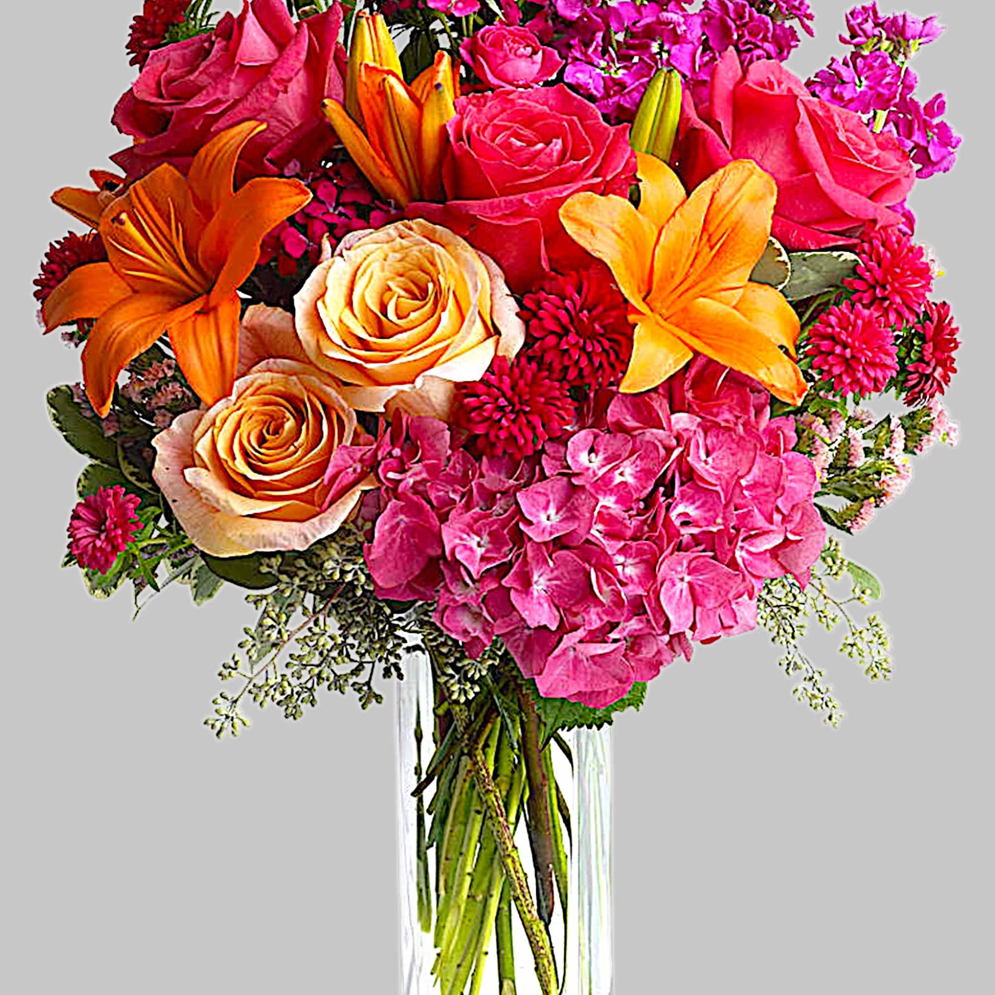 Bright mixed bouquet of roses, lilies, and pink hydrangeas in a clear vase, photo 4 of 4