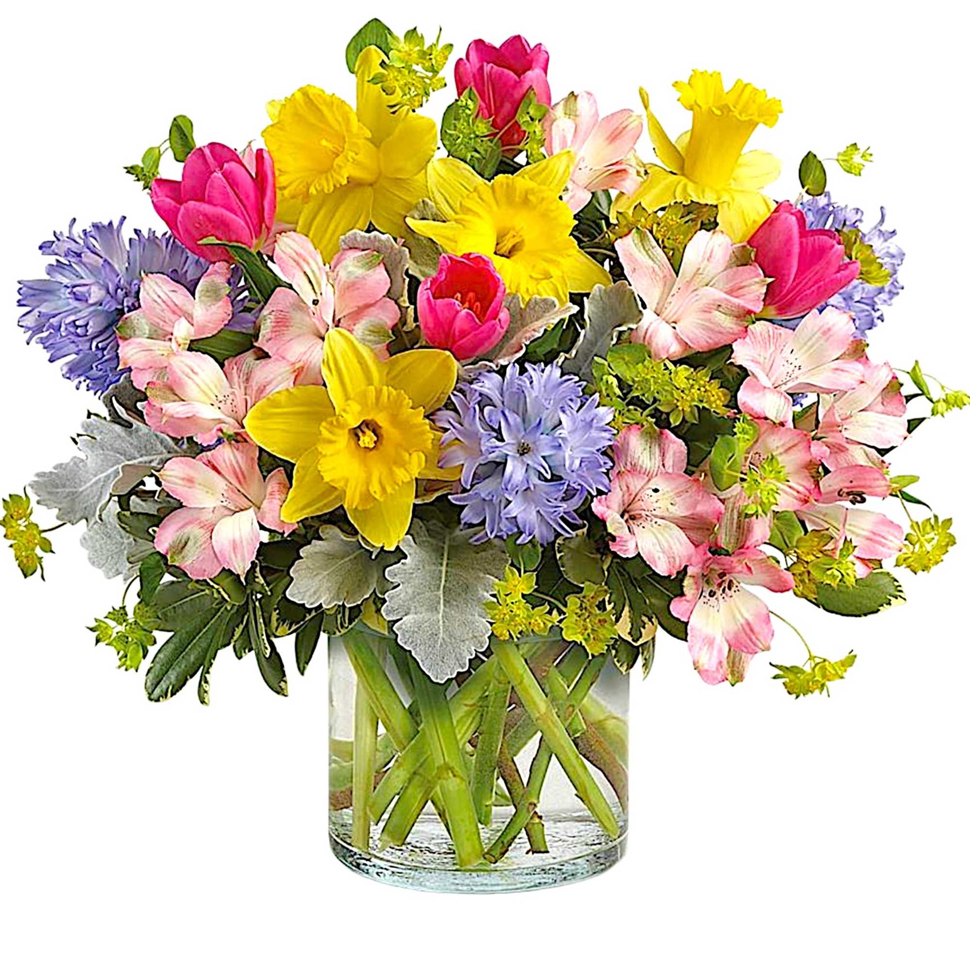 Mixed bouquet of yellow daffodils, pink tulips, and lavender flowers in a glass vase