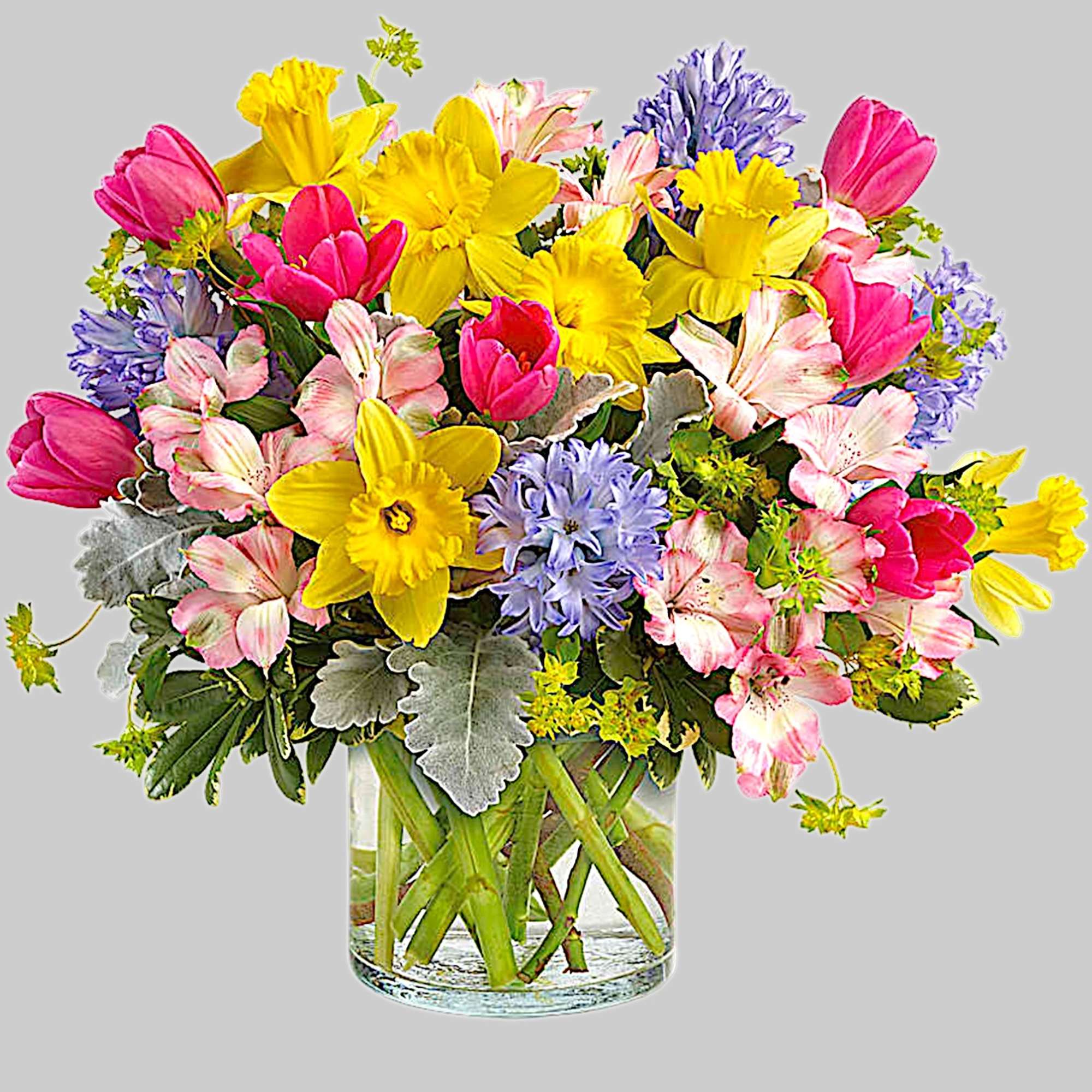 Colorful bouquet of tulips, daffodils, and alstroemeria in a glass vase, photo 4 of 4
